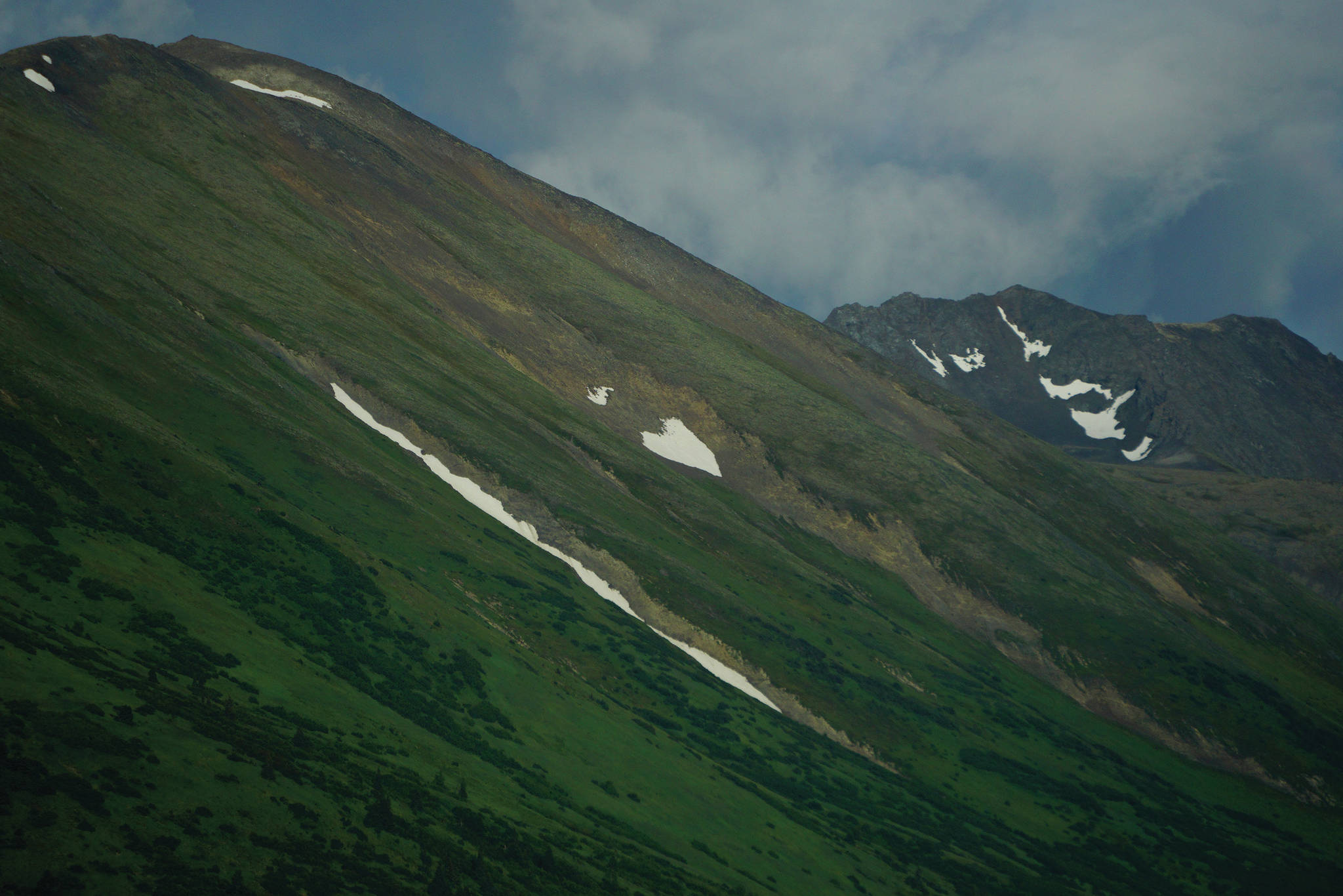 A patch of heart-shaped snow clings to the side of the Kenai Mountains on Tuesday, July 21, 2020, near Hope, Alaska. (Photo by Michael Armstrong/Homer News)