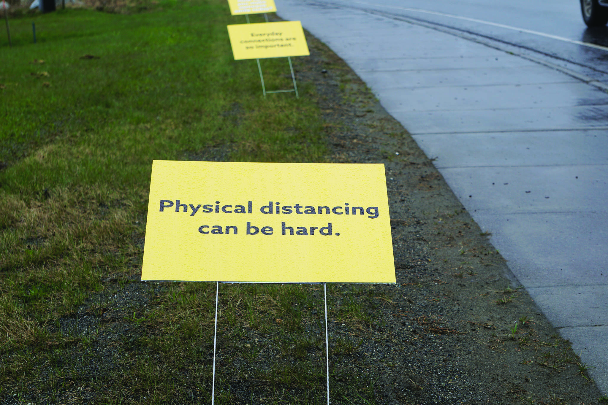 Signs on May 7, 2020, along the Sterling Highway by St. Augustine’s Episcopal Church in Homer, Alaska, and put up by the South Kenai Peninsula Resiliency Coalition offer encouragement during the COVID-19 pandemic. The signs read “Physical distancing can be hard. Everyday connections are so important. How can you make someone smile today?” (Photo by Michael Armstrong/Homer News)