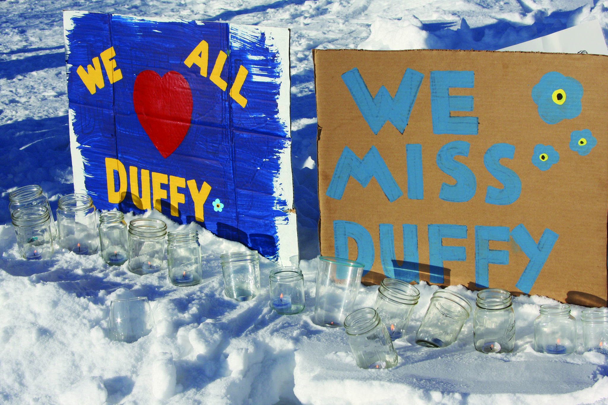 Painted signs posted at the candlelight vigil held for Anesha “Duffy” Murnane on Saturday, Feb. 1, 2020, at WKFL Park in Homer, Alaska, affirm love for Murnane and beseech her safe return. (Photo by Delcenia Cosman)