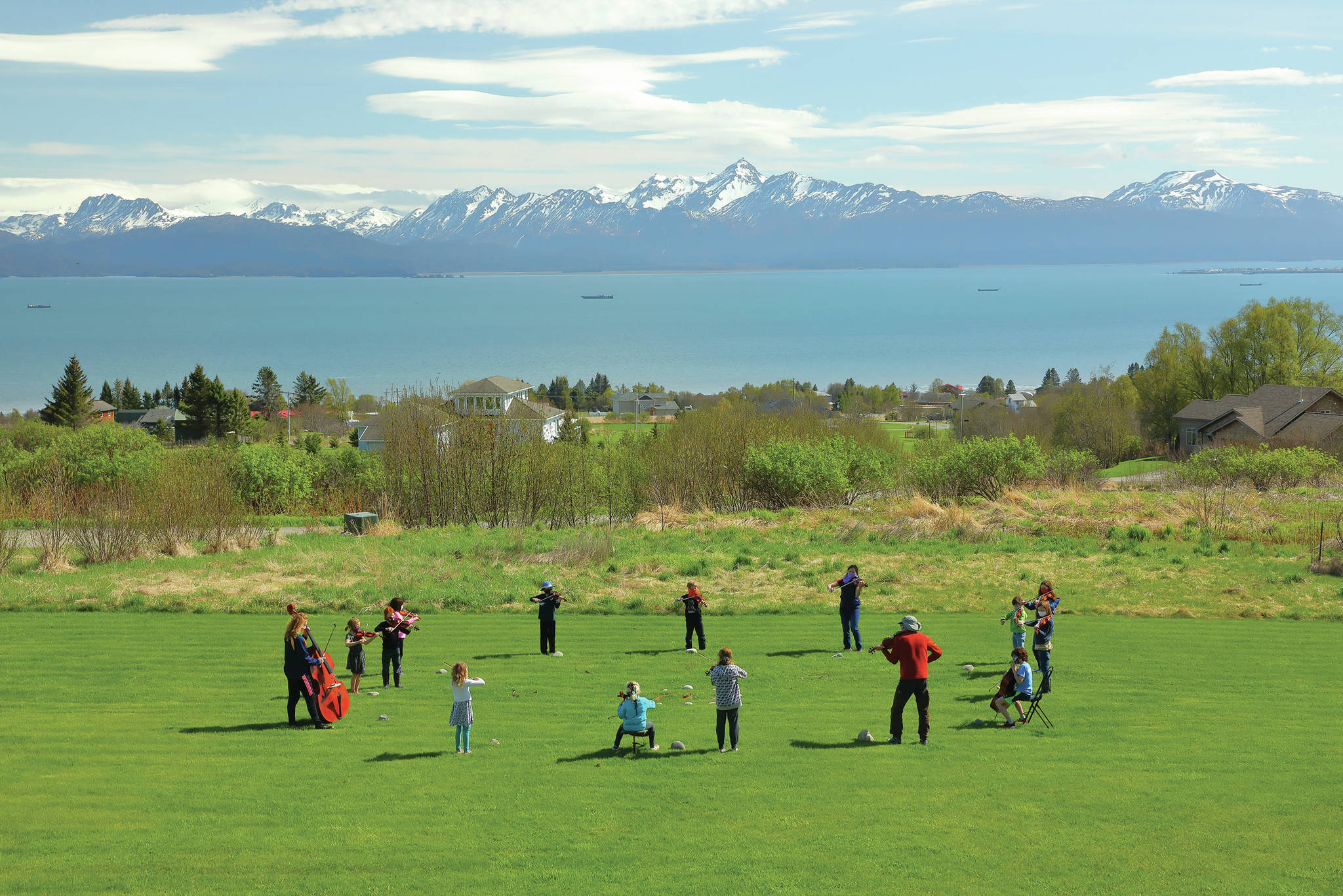 Members of the Homer Youth String Orchestra Club perform while practicing physical distancing on May 15, 2020, in Homer, Alaska. (Photo by Aaron Christ)