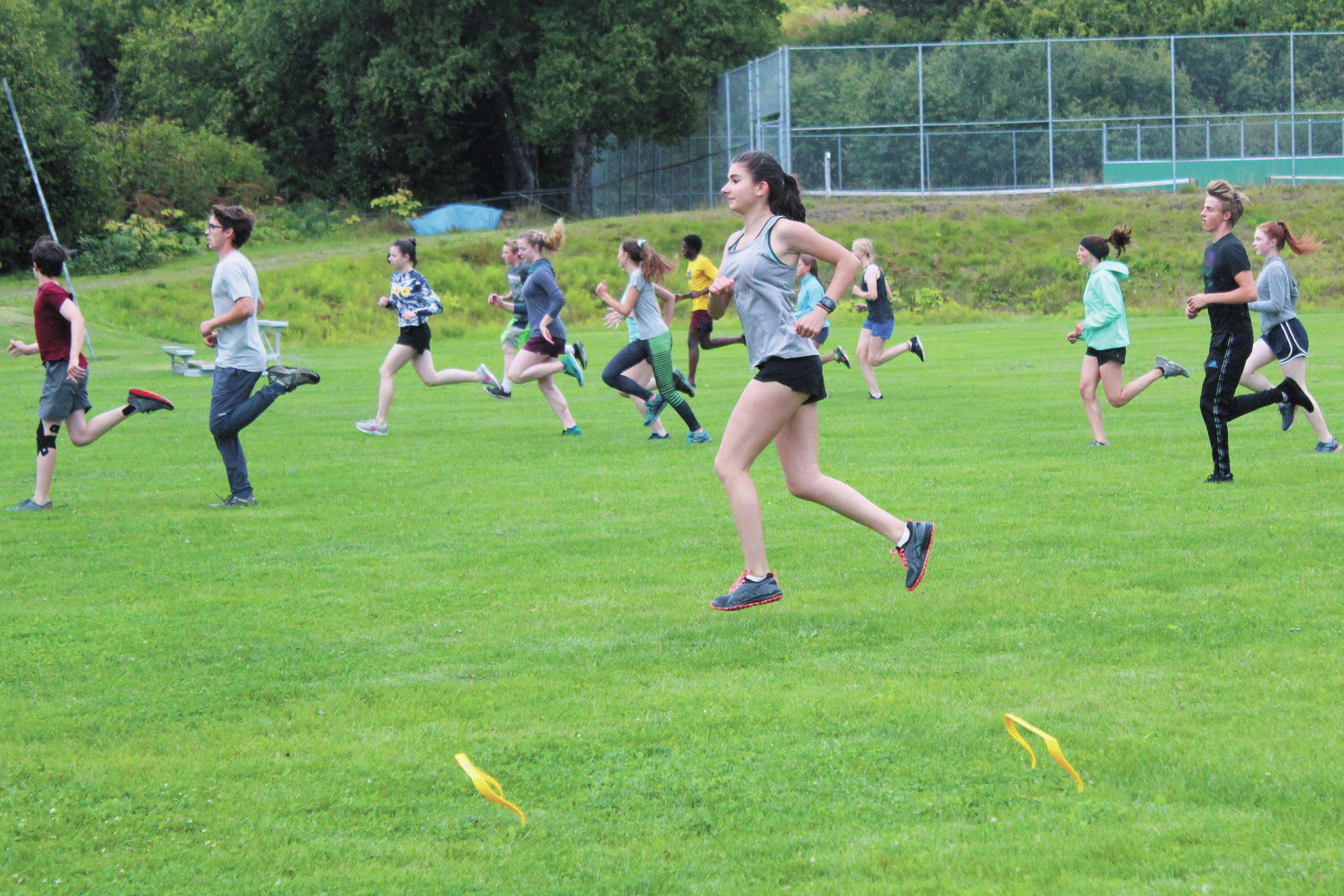 Members of the Homer High School cross country team perform warm up drills at a practice Tuesday, Aug. 18, 2020 at the school in Homer, Alaska. (Photo by Megan Pacer/Homer News)