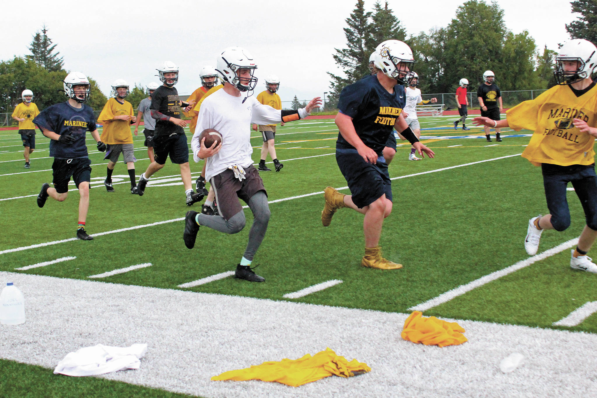 Members of the Homer Mariners football team practice outside on the turf field on Tuesday, Aug. 18, 2020 at Homer High School in Homer, Alaska. (Photo by Megan Pacer/Homer News)