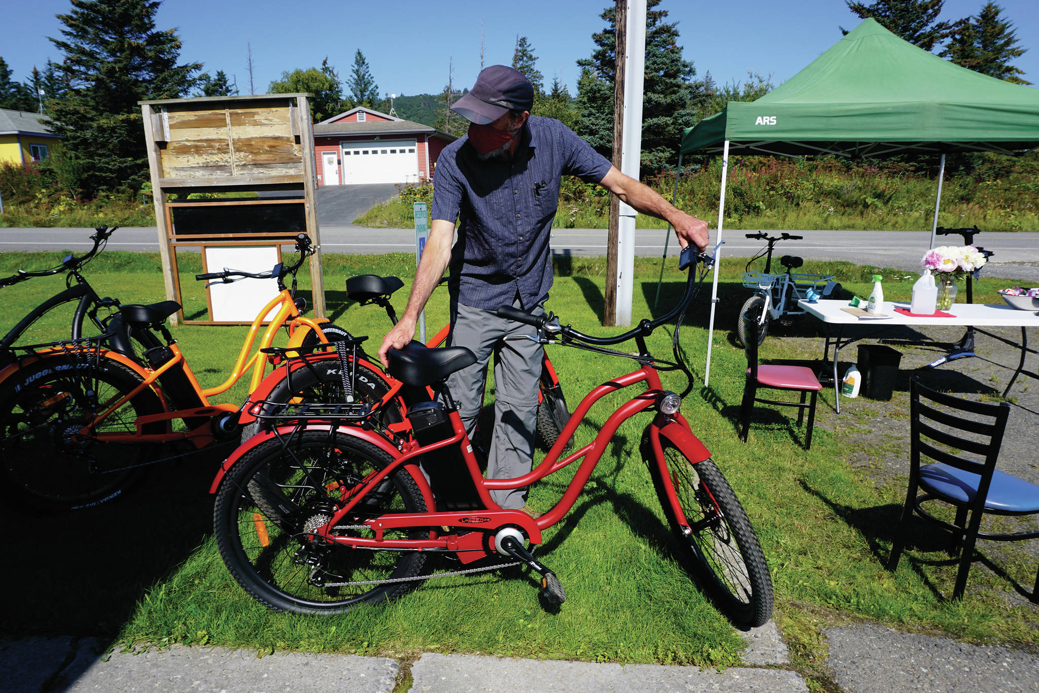 Dale Banks, owner of LoopEride, displays some of the electric-motor assist bicycles at an open house held Friday, Aug. 21, 2020, at his showroom on East Bunnell Avenue in Homer, Alaska. (Photo by Michael Armstrong/Homer News)