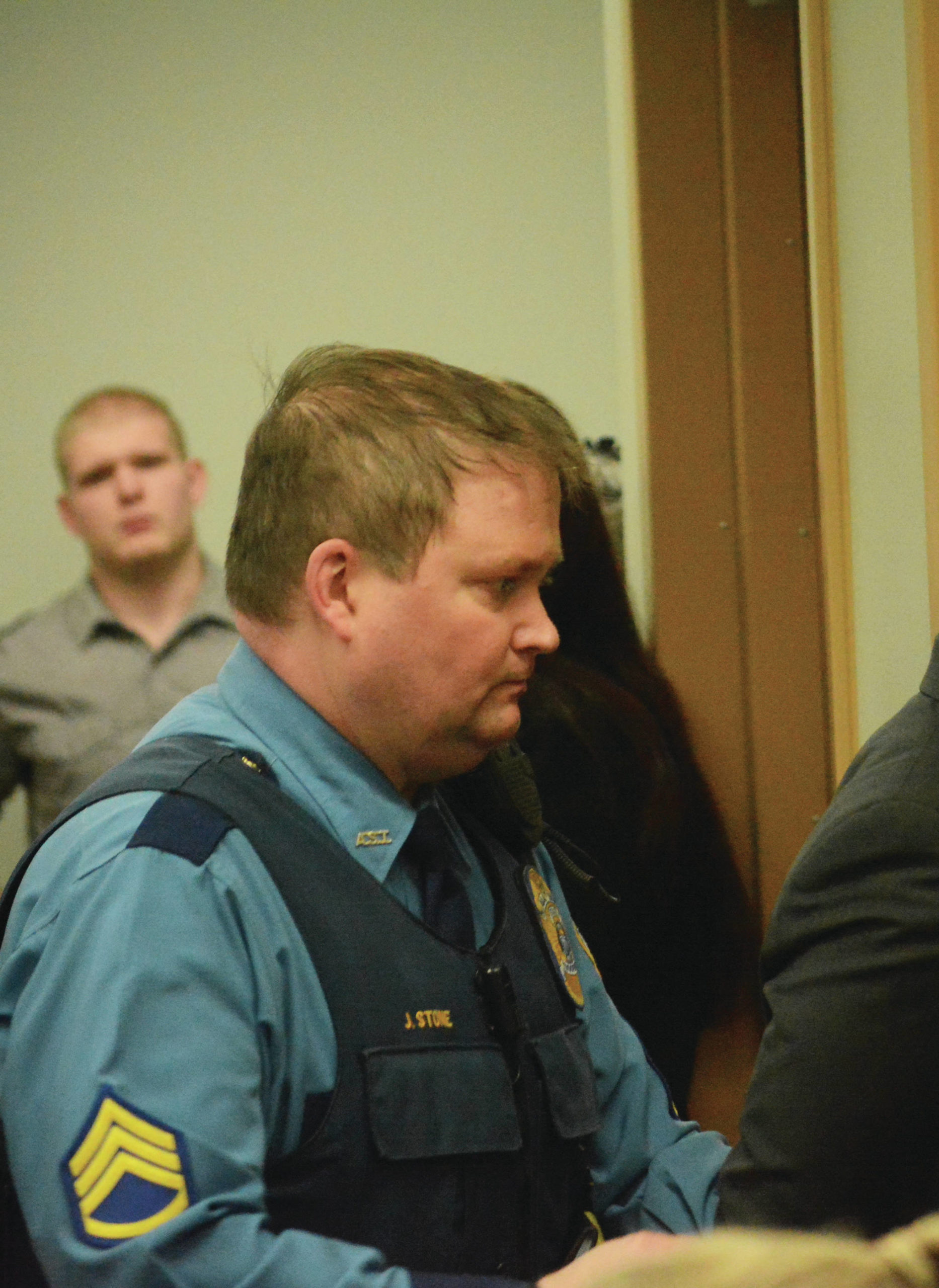 Former Alaska State Trooper Sgt. Jeremy Stone leads a defendant out of a courtroom at the Homer Courthouse at the conclusion of a sentencing hearing on March 12, 2015, in Homer, Alaska. (Photo by Michael Armstrong/Homer News)