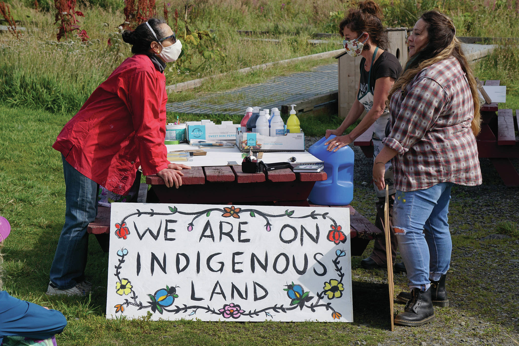 Melissa Shaginoff, right, speaks with Rika Mouw, left, and Asia Freeman, center, at “Land Acknowledgement in Action: Sign Installation” last Saturday, Aug. 22, 2020, at the Bishop’s Beach pavillion — the area known by the Dena’ina people as “Tuggeht,” or “at the water’s edge.” (Photo by Michael Armstrong/Homer News.