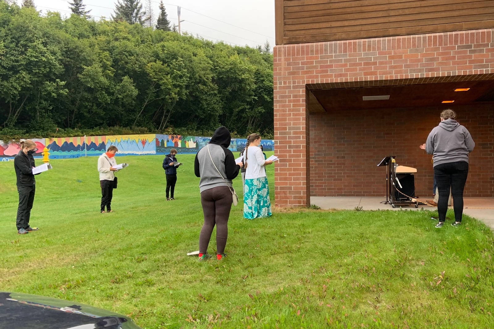 Members of the Homer Swing Choir practice outdoors on the first day of school, Monday, Aug. 24, 2020 at Homer High School in Homer, Alaska. (Photo courtesy Homer High School)