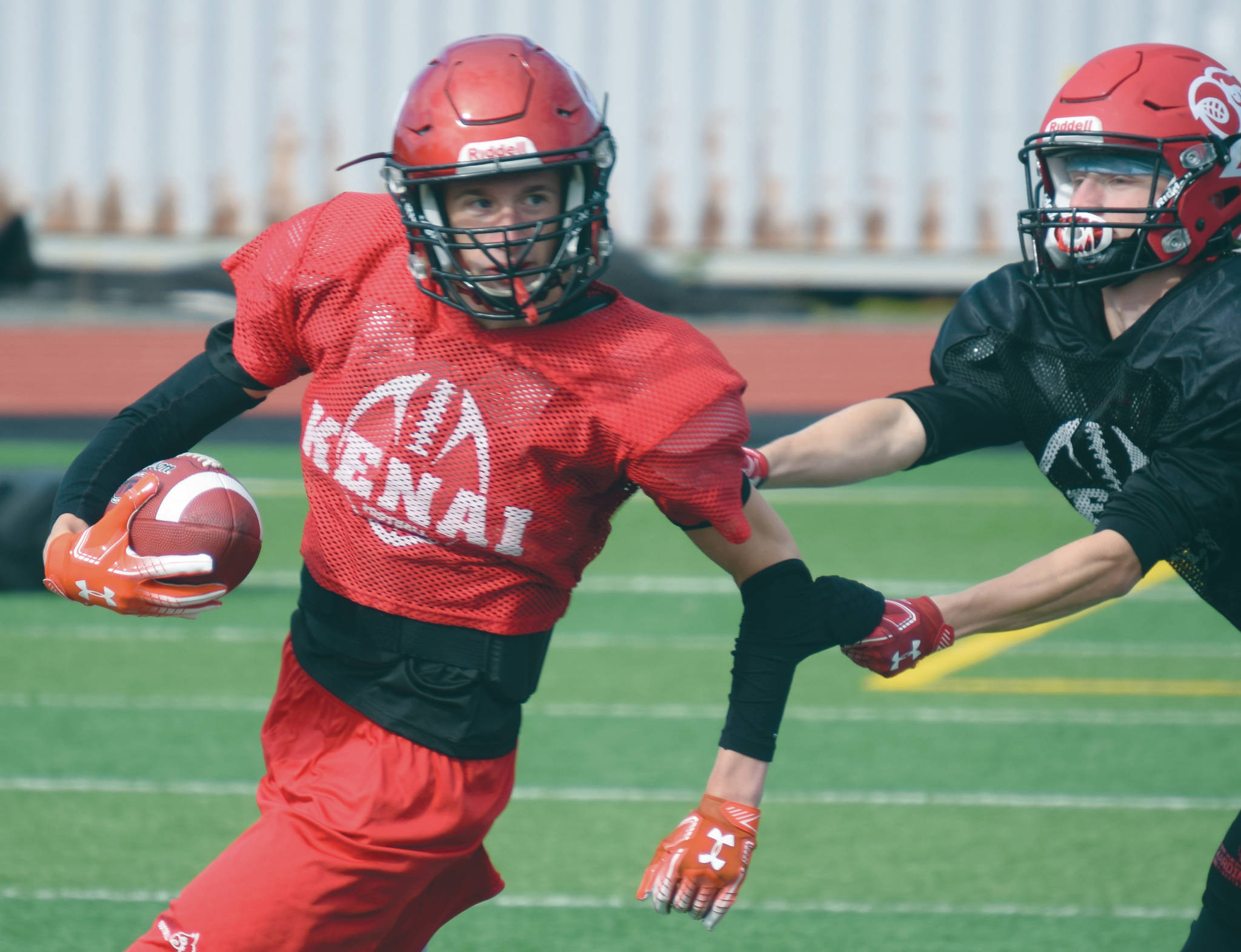 Photo by Jeff Helminiak / Peninsula Clarion                                Luke Armstrong and James Sparks practice punt return and coverage Monday, Aug. 31, at Ed Hollier Field at Kenai Central High School in Kenai.