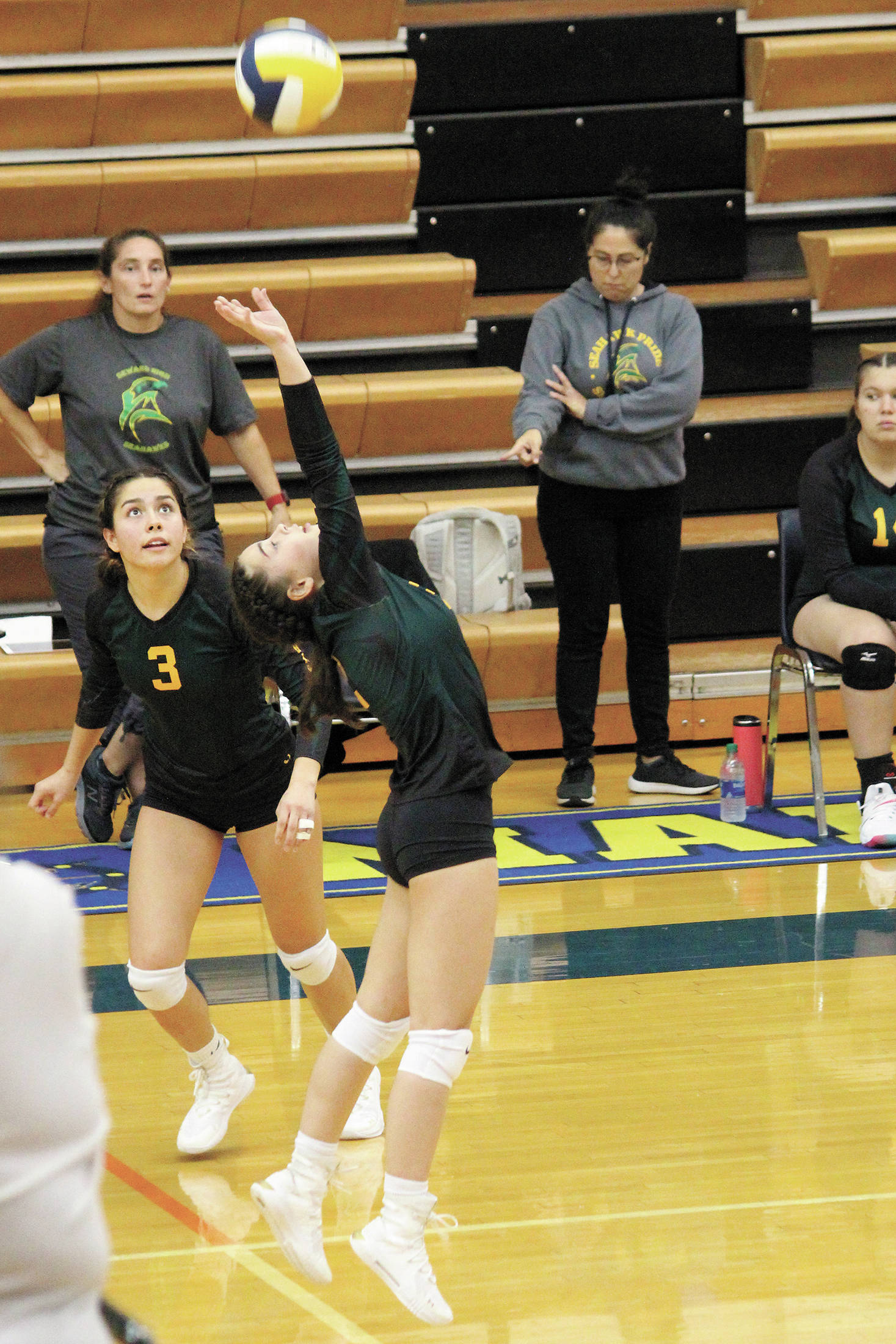 Seward’s Hannah Schilling sets the ball to teammate Gaia Casagranda (No. 3) during a Friday, Sept. 4, 2020 volleyball game against Homer High School in the Alice Witte Gymnasium in Homer, Alaska. (Photo by Megan Pacer/Homer News)