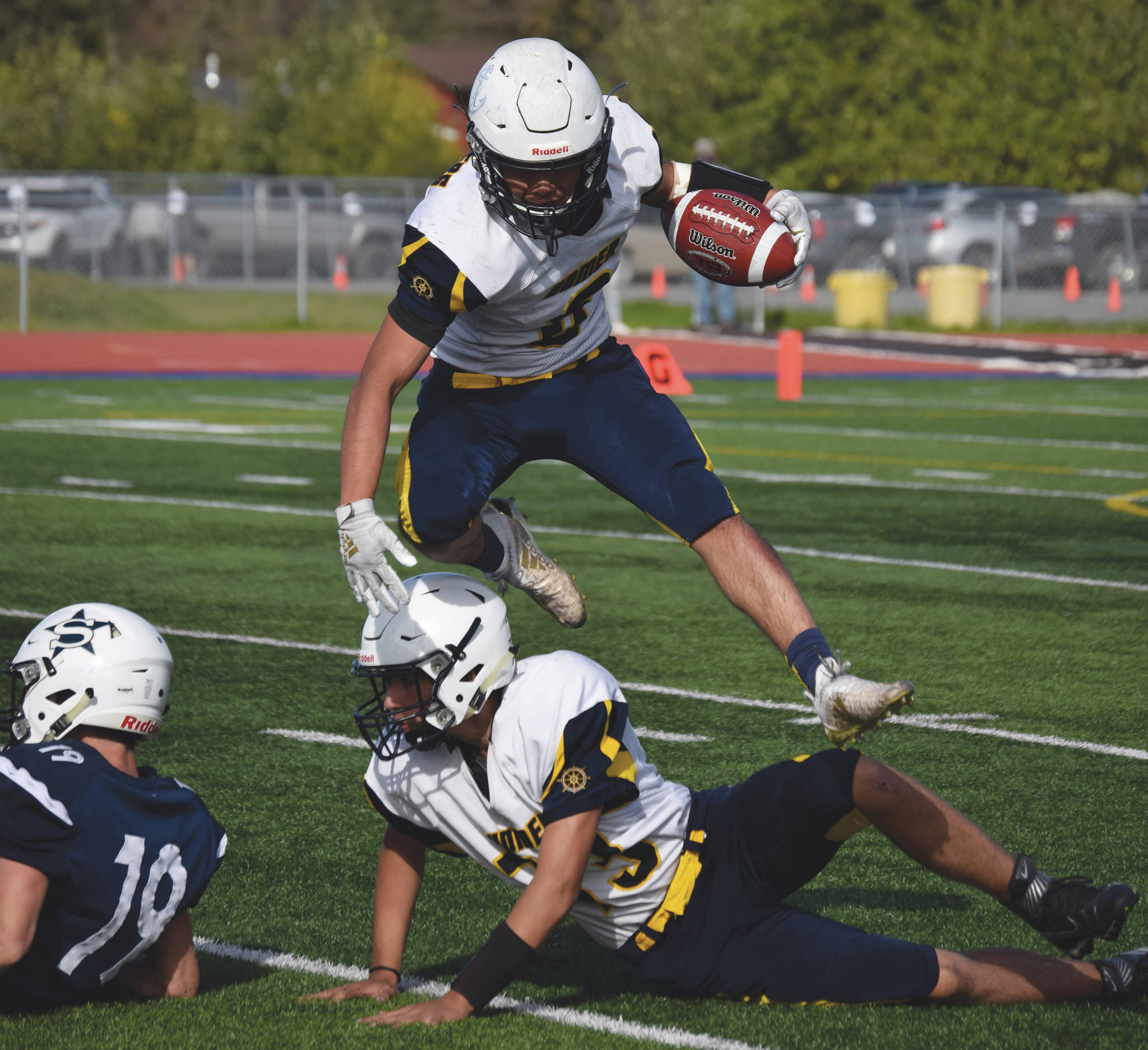 Homer’s Sly Gaona jumps over teammate Eddie Robinett on Saturday, Sept. 5, 2020, at Justin Maile Field at Soldotna High School in Soldotna, Alaska. (Photo by Jeff Helminiak/Peninsula Clarion)