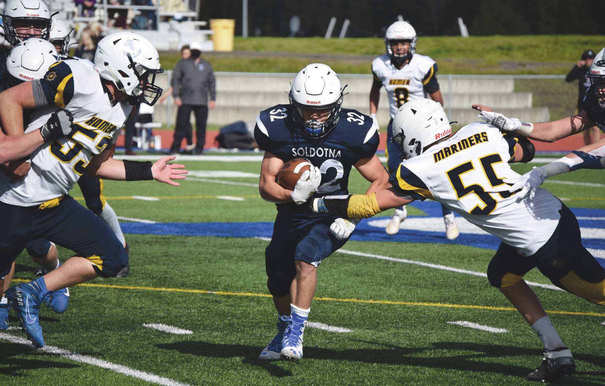 Homer’s Josh Manwiller and Dodge Petrosius converge on Soldotna’s Dennis Taylor on Saturday, Sept. 5, 2020, at Justin Maile Field at Soldotna High School in Soldotna, Alaska. (Photo by Jeff Helminiak/Peninsula Clarion)
