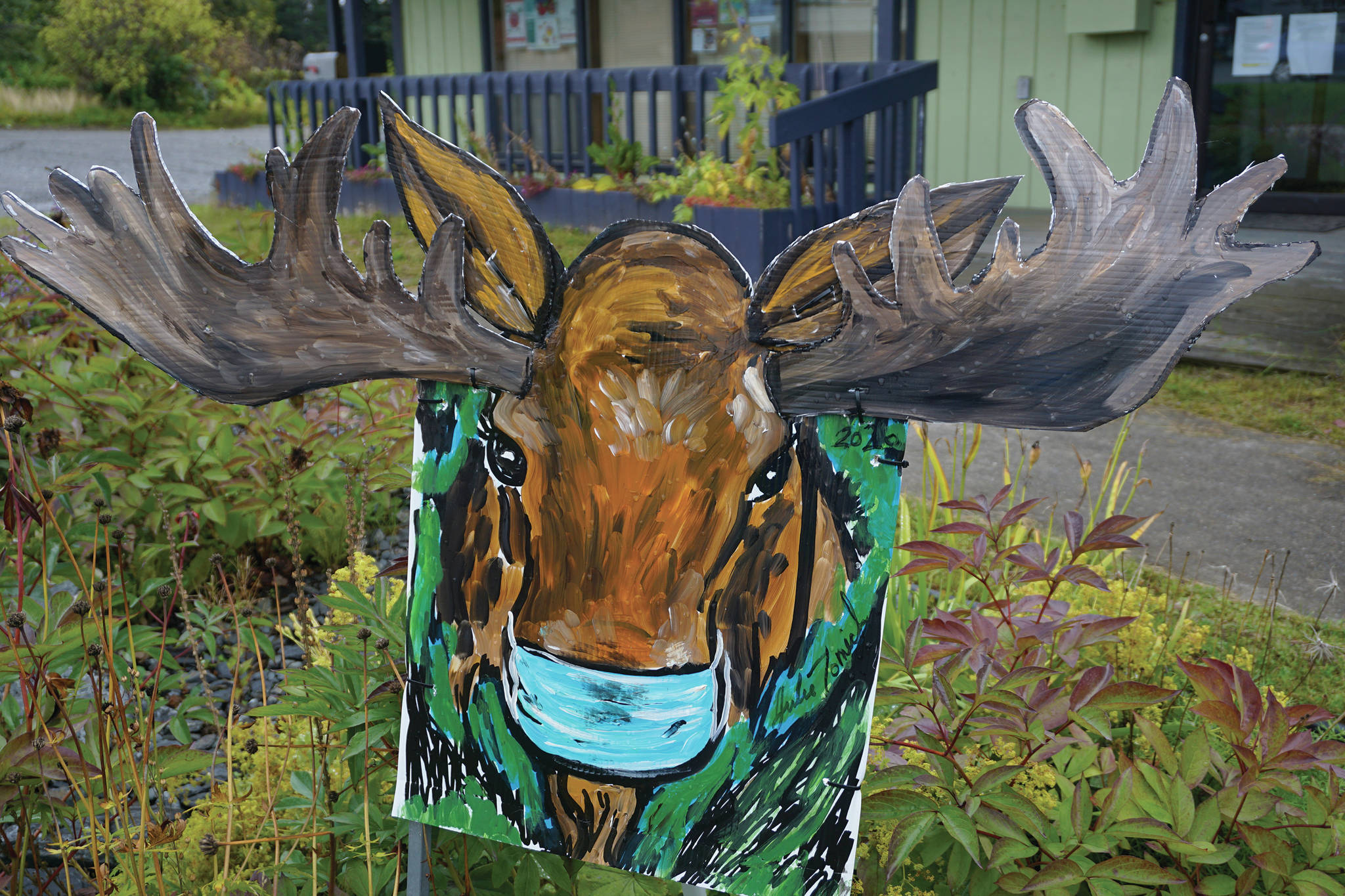 A painting of a masked moose by Julianne Tomich is in front of the Homer Council on the Arts on Thursday, Sept. 3, 2020, in Homer, Alaska. (Photo by Michael Armstrong/Homer News)
