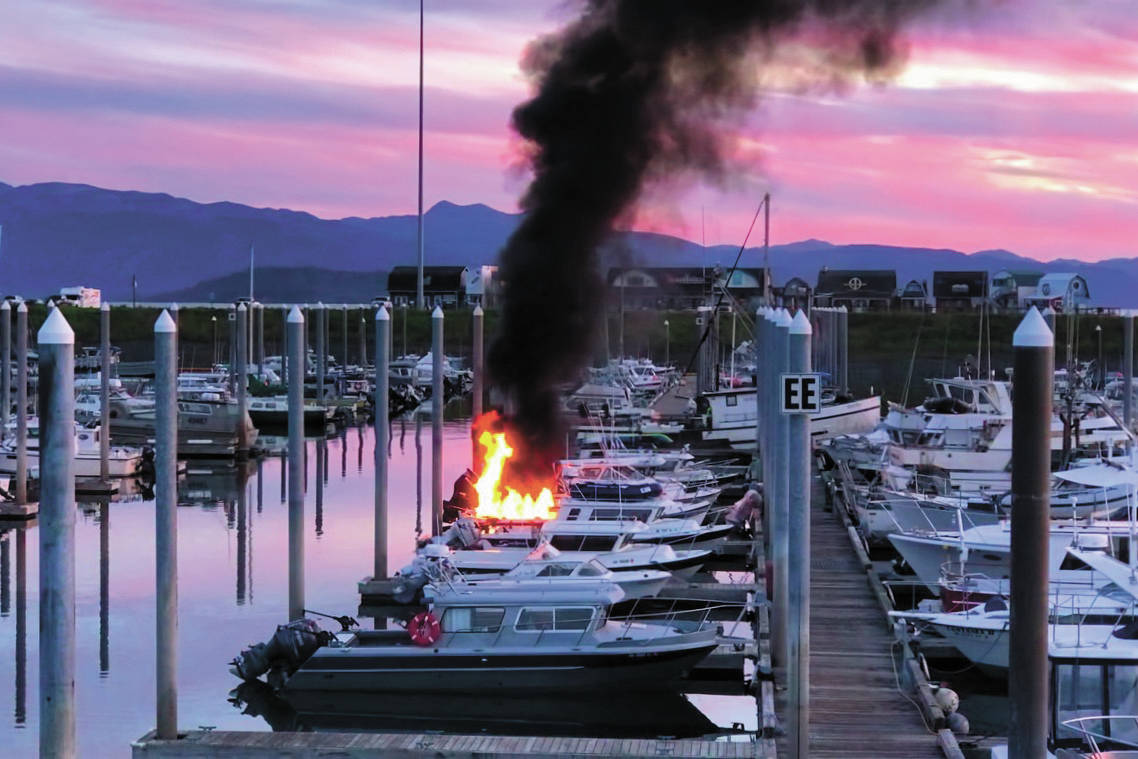 Flames and smoke rise from a 32-foot fiberglass boat docked in the Homer Harbor on the evening of Friday, Sept. 11, 2020 in Homer, Alaska. No one was harmed and the Homer Volunteer Fire Department put out the fire. (Photo by John Pratt)
