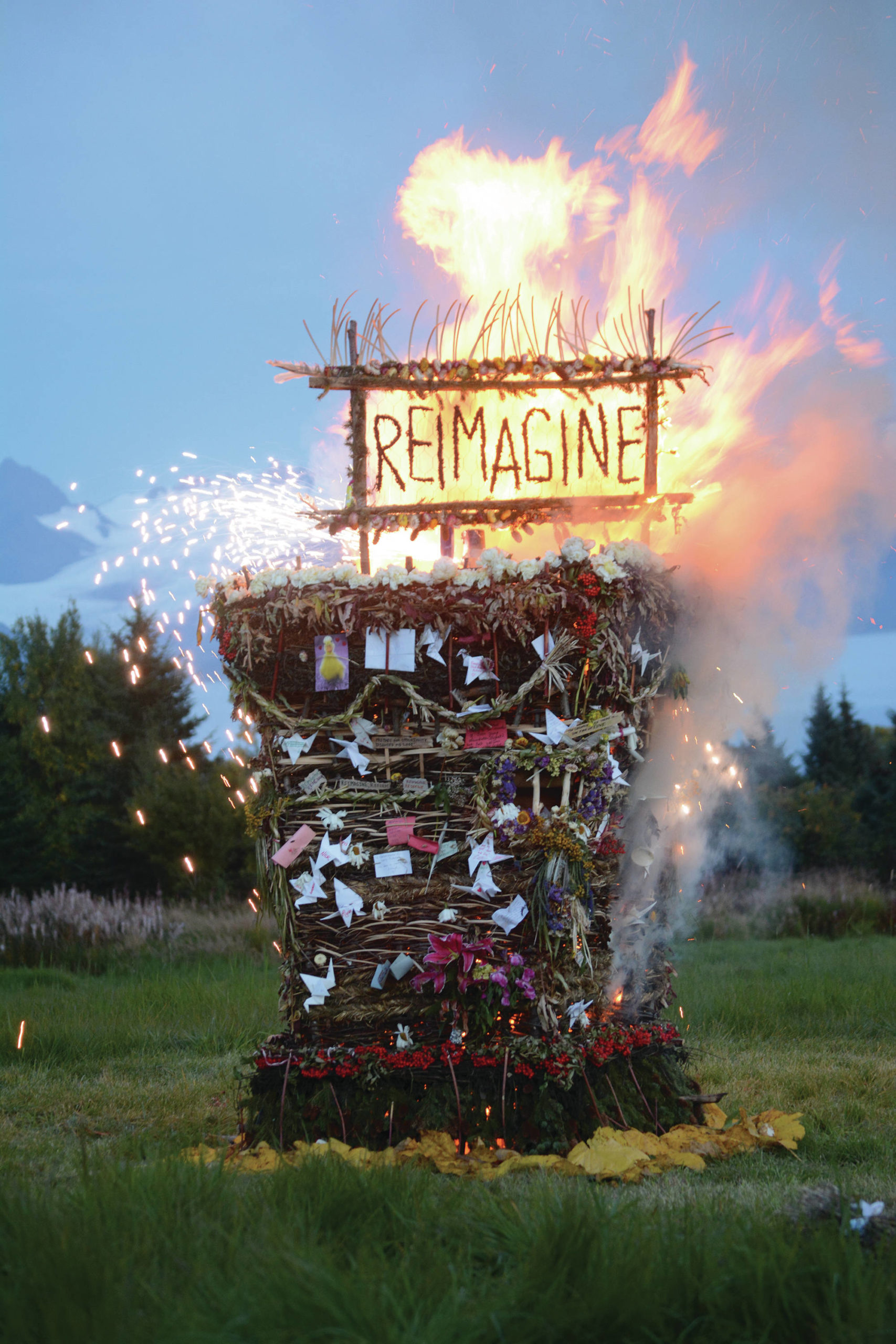 “Reimagine,” the 17th annual Burning Basket, catches fire in a field on Sunday, Sept. 13, 2020, near Homer, Alaska. Artist Mavis Muller intended to broadcast live on Facebook and YouTube the burning of the basket, but because of technical difficulties that didn’t happen. “Burning Basket teaches how to let go of expectations and accept the present moment,” Muller wrote in a text message. “Technology is fickle. The basket, however, did exactly what it promised to do. It helod our collective burderns, our memorials, our joys, sadness, fear, and dispersed all of our good intentions in a plume of smoke, sparks and flames.” (Photo by Michael Armstrong/Homer News)