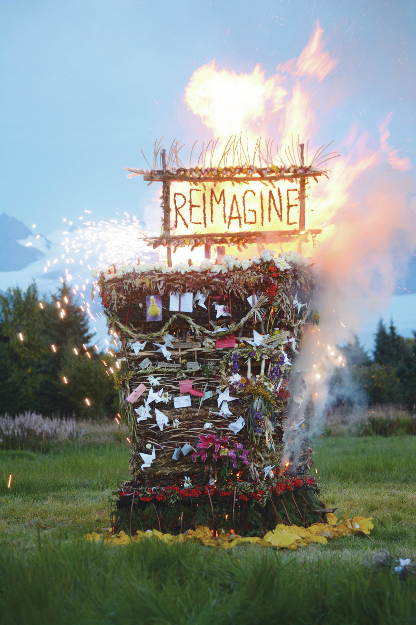 “Reimagine,” the 17th annual Burning Basket, catches fire in a field on Sunday, Sept. 13, near Homer. Artist Mavis Muller intended to broadcast live on Facebook and YouTube the burning of the basket, but because of technical difficulties that didn’t happen. “Burning Basket teaches how to let go of expectations and accept the present moment,” Muller wrote in a text message. “Technology is fickle. The basket, however, did exactly what it promised to do. It helod our collective burderns, our memorials, our joys, sadness, fear, and dispersed all of our good intentions in a plume of smoke, sparks and flames.” (Photo by Michael Armstrong/Homer News)