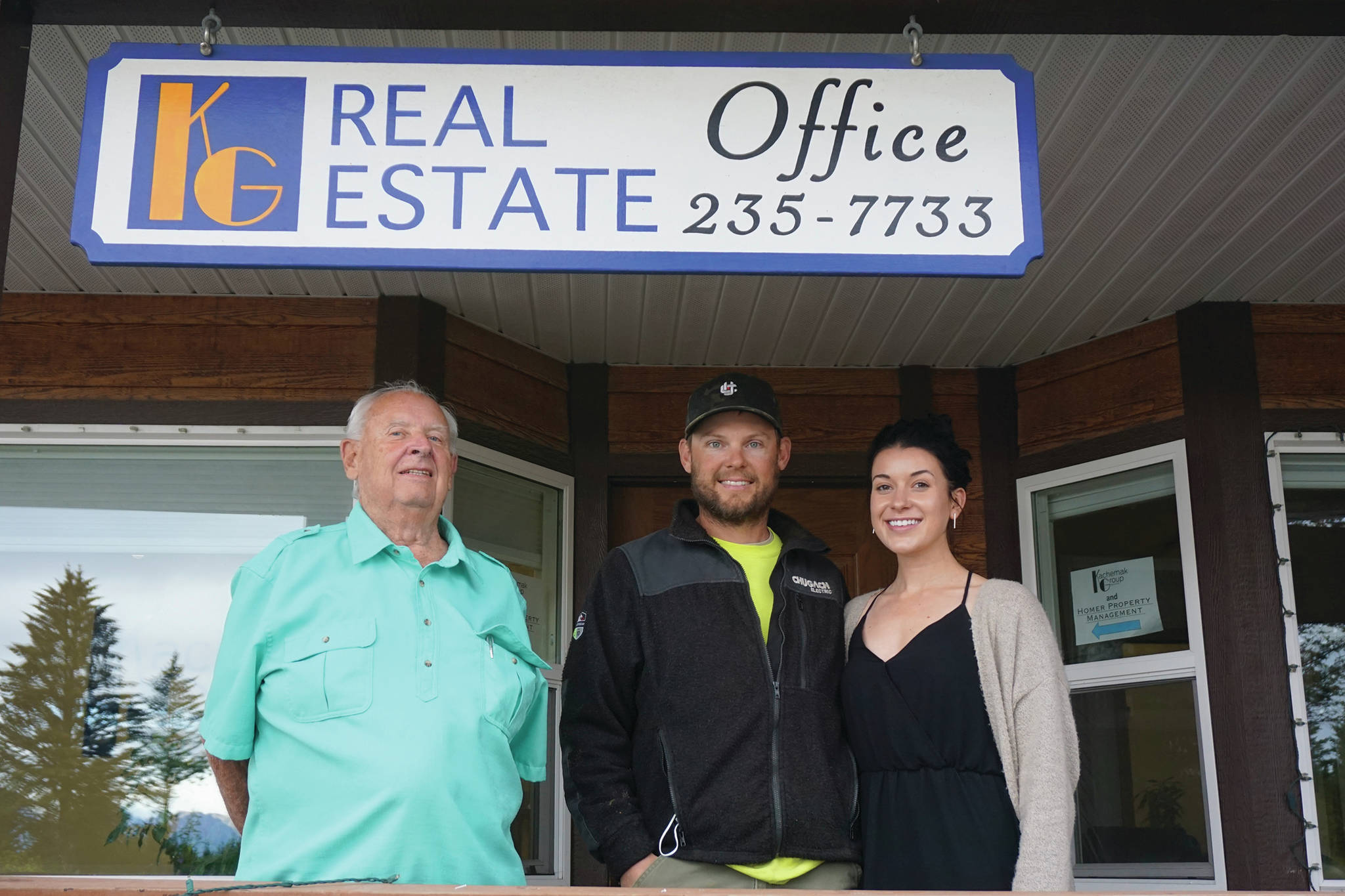 Terry Yager, left, poses with new Kachemak Group Realty owner Valerie Buss, far right, and her husband, Bryce Buss, center, on Tuesday, Sept, 15. 2020, at the agency’s office on West Pioneer Avenue in Homer, Alaska. (Photo by Michael Armstrong/Homer News)