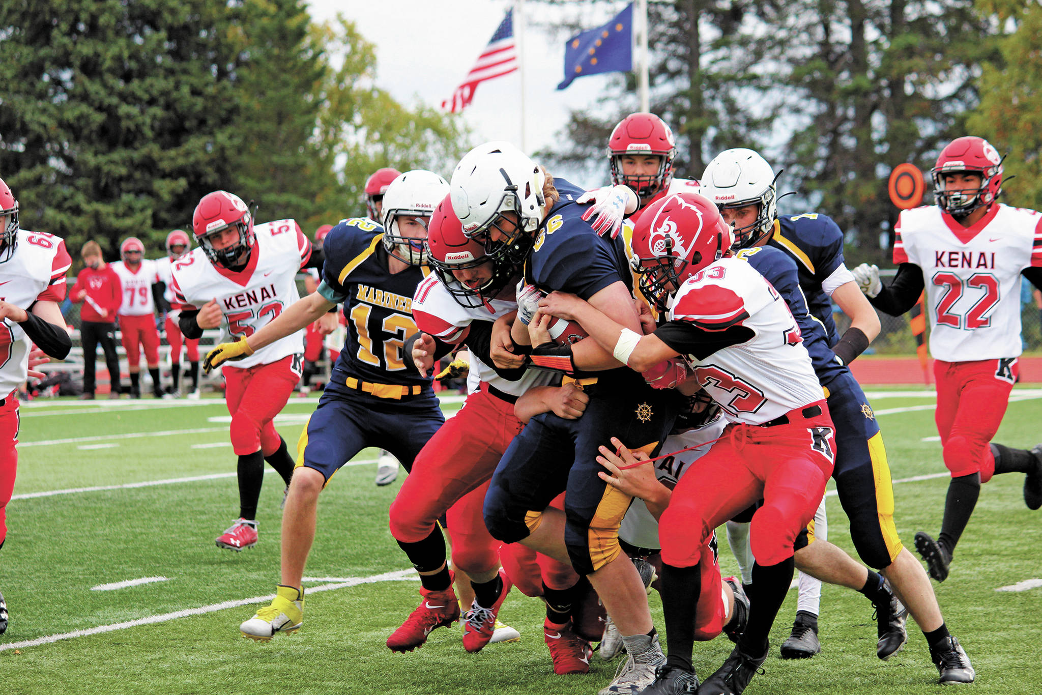 Homer’s River Mann is tackled by a group of Kardinals during a Saturday, Sept. 19, 2020 football game against Kenai Central High School at Homer High School in Homer, Alaska. The Mariners won 44-6. (Photo by Megan Pacer/Homer News)