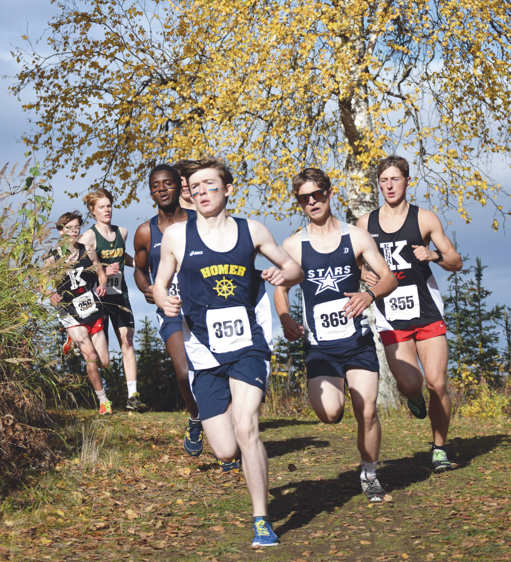 Homer’s Lance Seneff leads the pack in the first kilometer of the Region III/Southern Division boys race Saturday, Oct. 3, 2020, at Tsalteshi Trails just outside of Soldotna, Alaska. Race champion Maison Dunham of Kenai Central is at far right. (Photo by Jeff Helminiak/Peninsula Clarion)