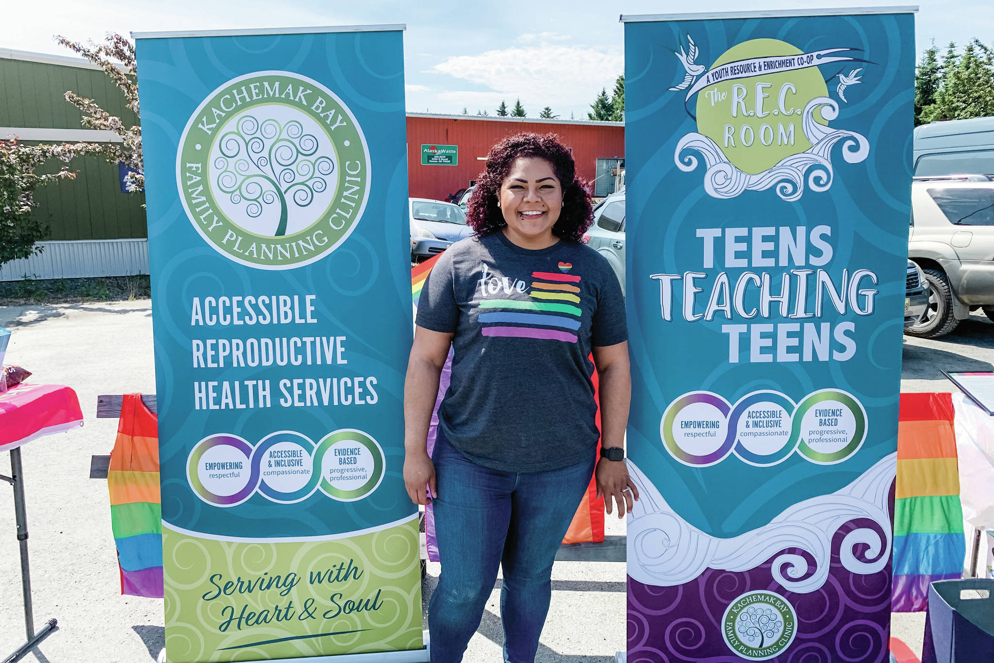 Xochitl Lopez-Ayala stands in front of the Kachemak Bay Family Planning Clinic booth at Pride 2019 on June 22, 2019, in Homer, Alaska. (Photo courtesy of Xochitl Lopez-Ayala)