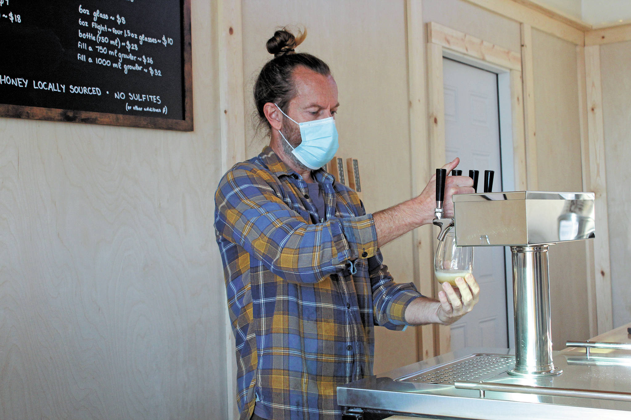 Jason Davis, owner of Sweetgale Meadworks and Cider House, pours a drink for a patron on Oct. 20, 2020 at the new business on Main Street in Homer, Alaska. (Photo by Megan Pacer/Homer News)
