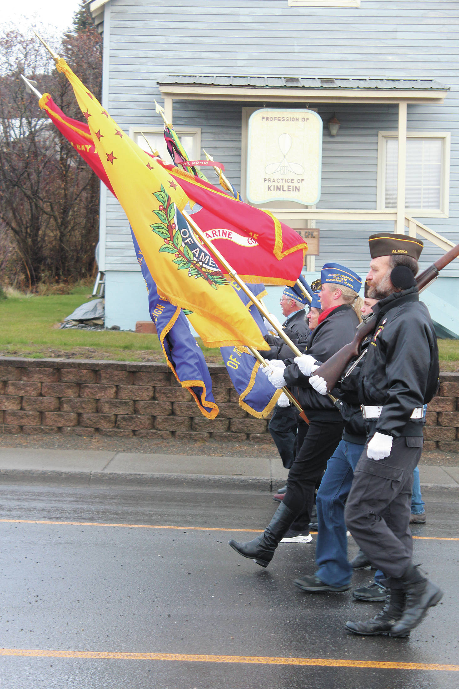 Participants in this year’s Veterans Day parade and celebration march down Pioneer Avenue on Tuesday, Nov. 11, 2020 in Homer, Alaska. (Photo by Megan Pacer/Homer News)