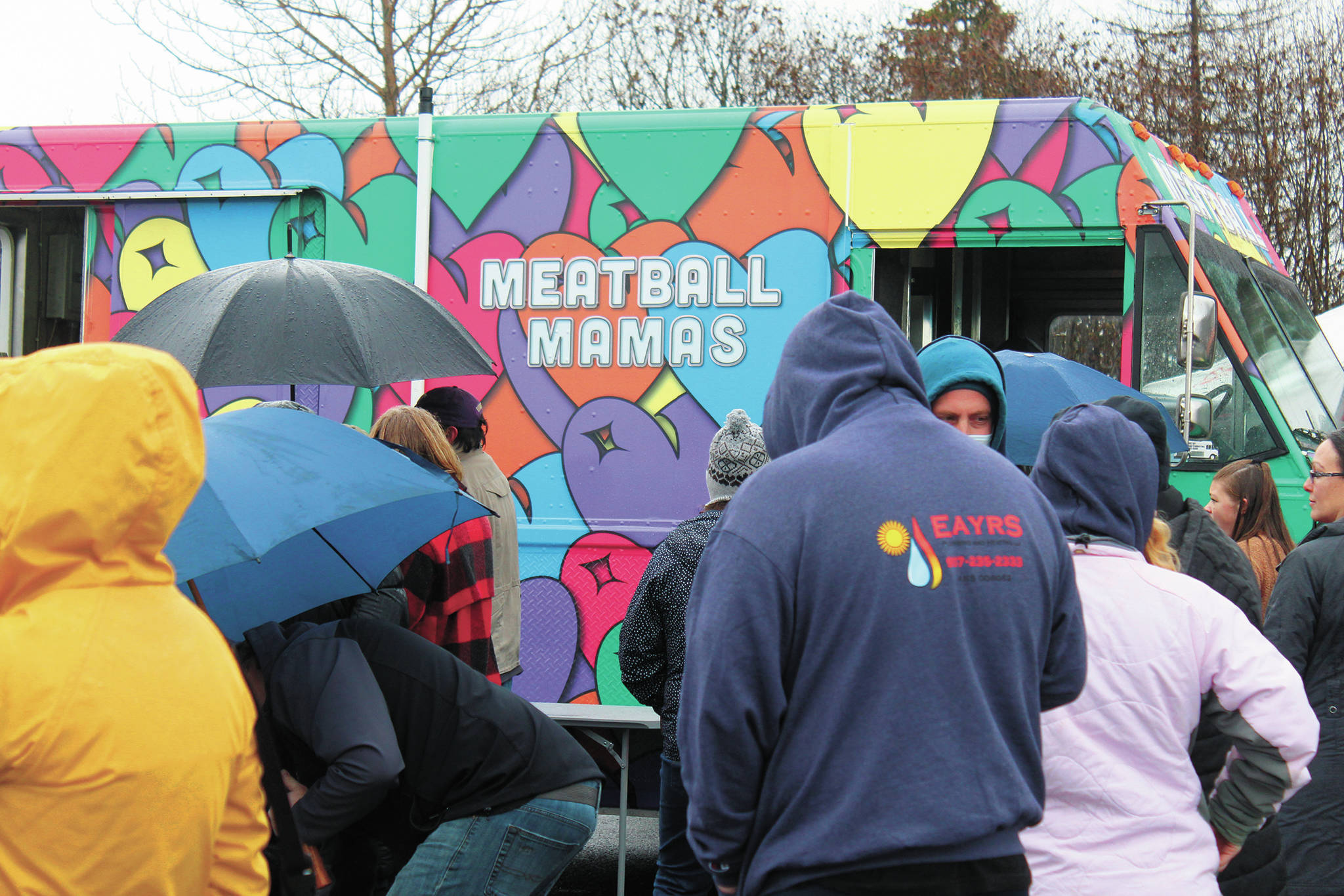 Locals wait on an overcast and rainy day to eat from the Meatball Mamas food truck on Sunday, Nov. 8, 2020 at the Homer Chamber of Commerce & Visitor Center in Homer, Alaska. The food truck was in town along with four others as part of the Food Network show “The Great Food Truck Race.” (Photo by Megan Pacer/Homer News)