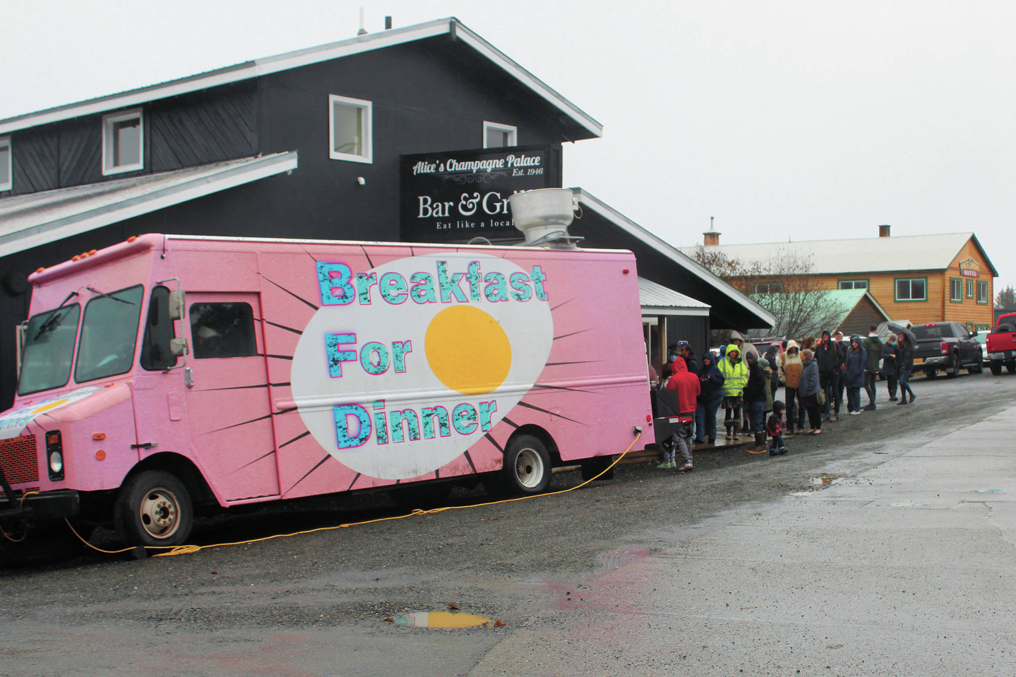 Locals wait in line to eat from the BFDfoodtruck (breakfast for dinner) on Sunday, Nov. 8, 2020 at Alice’s Champagne Palace in Homer, Alaska. The food truck was in town along with four others as part of the Food Network show “The Great Food Truck Race.” (Photo by Megan Pacer/Homer News)