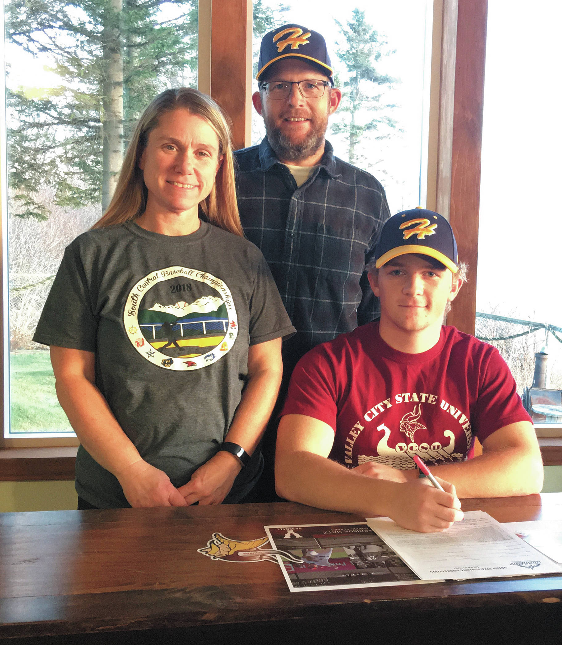 Harrison Metz (right) signs his National Letter of Intent to play baseball at Valley City State University. (Photo courtesy Kristin Metz)