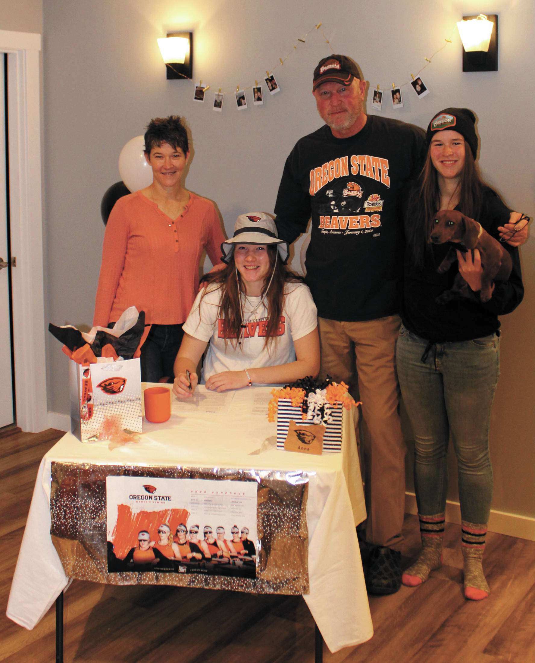Anna Godfrey (center) signs her National Letter of Intent to row at Oregon State University, with her mother Paula (left), father Dave (second from right) and sister Grace (right). (Photo credit Henry Freund)