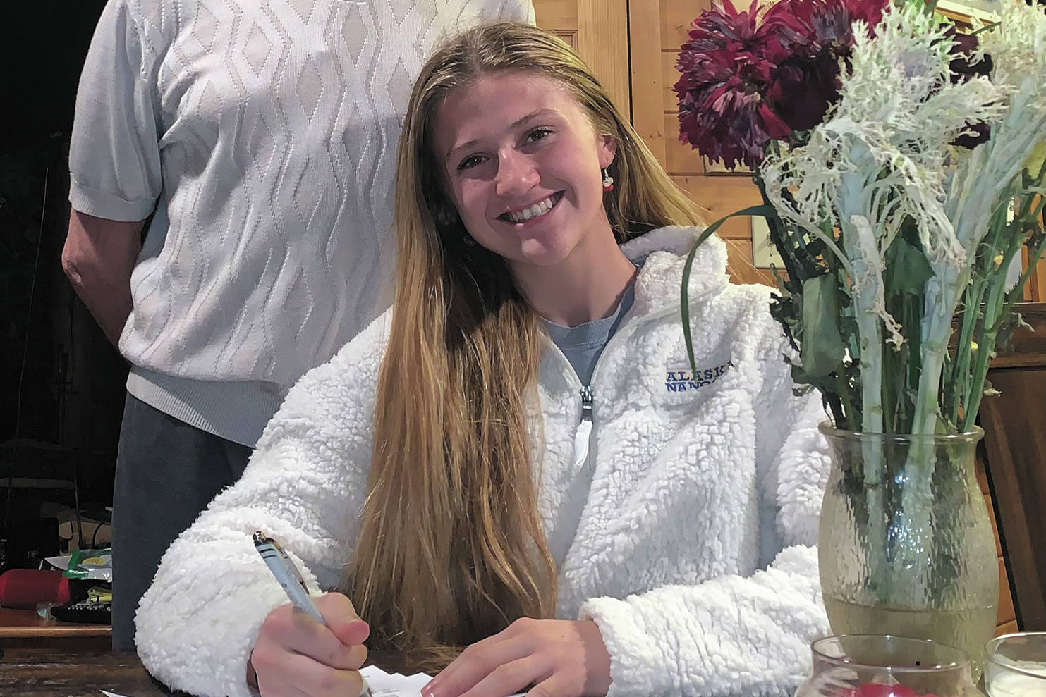 Homer senior Adeline Berry signs her National Letter of Intent to swim at University of Alaska Fairbanks with her dad, Jack Berry. (Photo courtesy Adeline Berry)