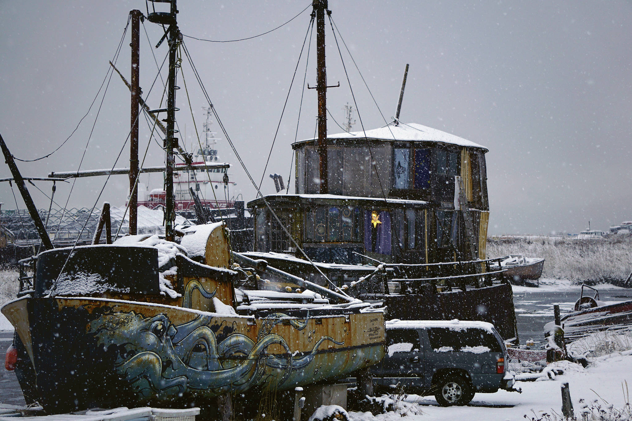 Snow falls on the Cape Lynch, right, and other boats on Sunday, Nov. 29, 2020, on the Homer Spit in Homer, Alaska. (Photo by Michael Armstrong/Homer News).