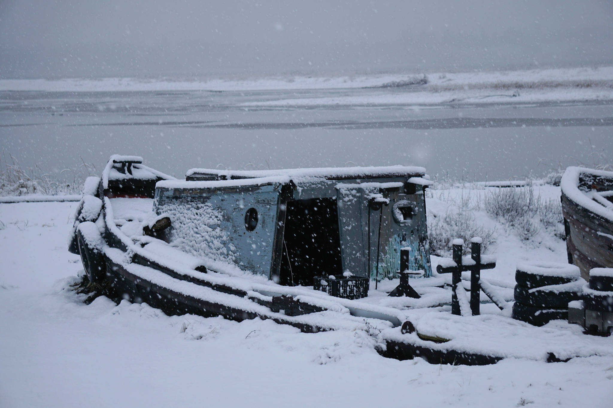 Snow falls on an old boat on Sunday, Nov. 29, 2020, on the Homer Spit in Homer, Alaska. (Photo by Michael Armstrong/Homer News).