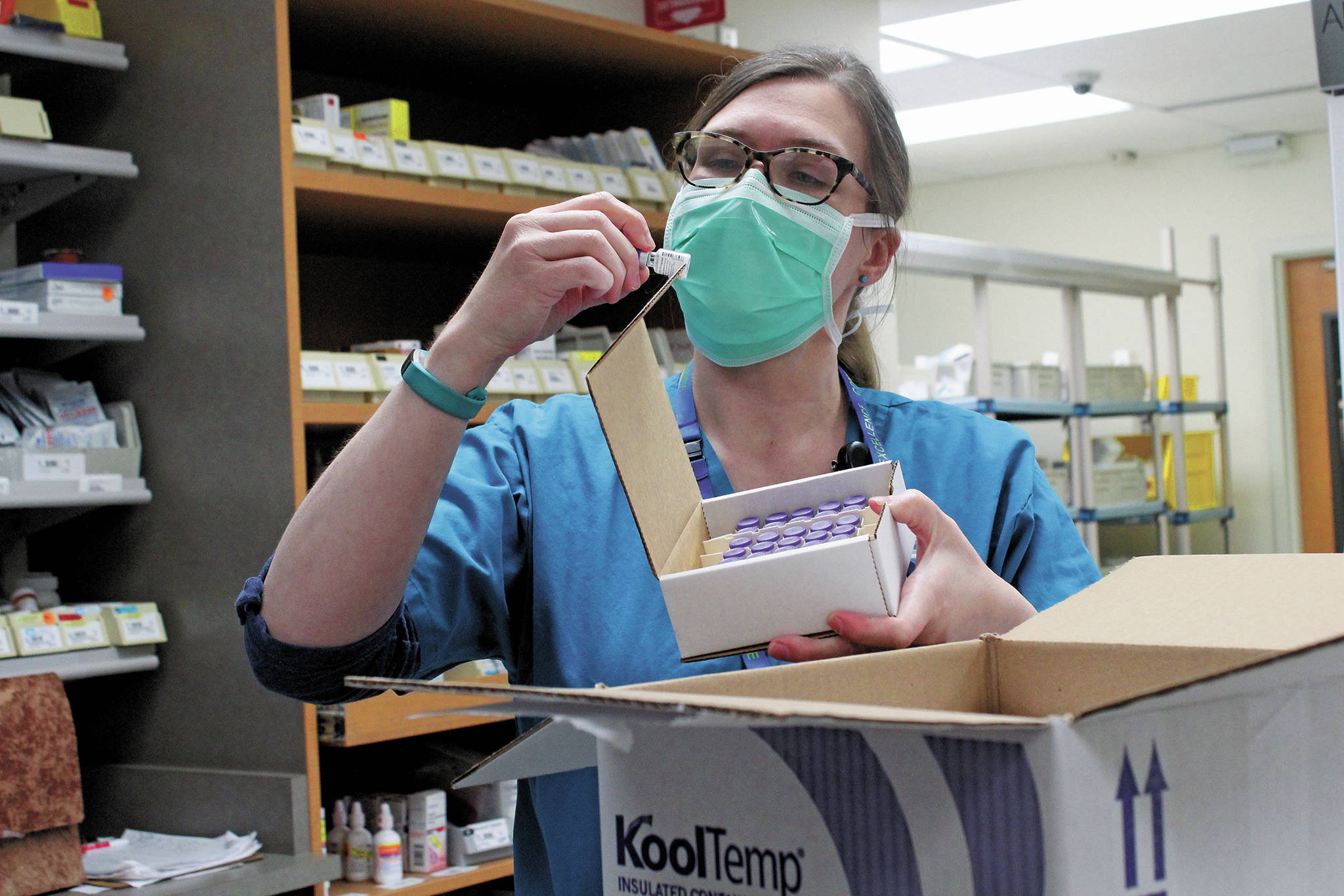 South Peninsula Pharmacist Jill Kort examines a vial of the Pfizer vaccine for COVID-19 shortly after it arrived at the hospital on Wednesday, Dec. 16, 2020 in Homer, Alaska. (Photo by Megan Pacer/Homer News)