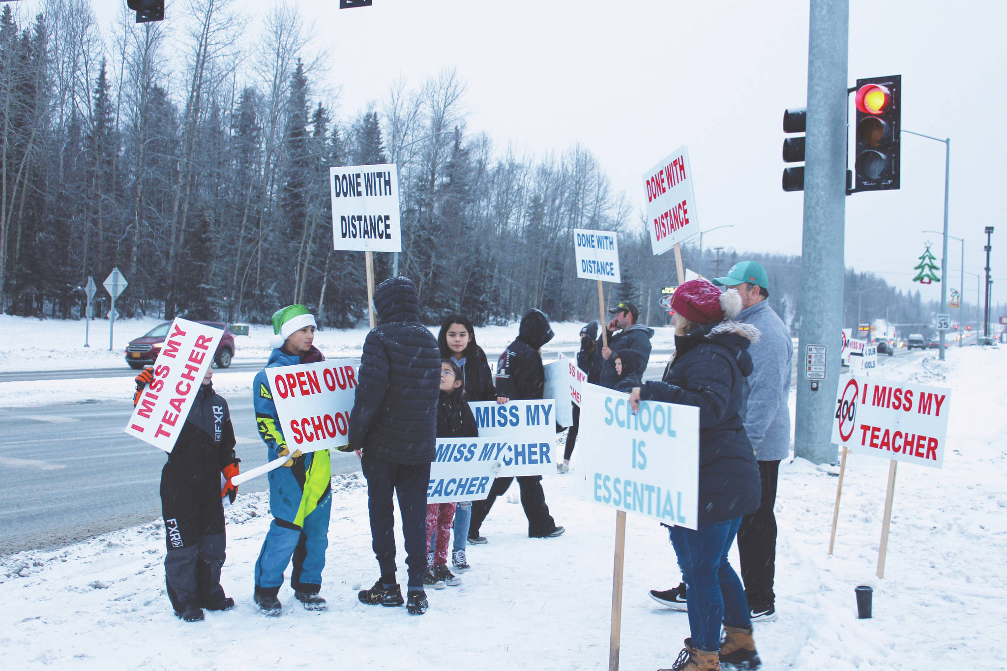 Protestors are seen at the intersection of Kenai Spur Hwy. and Sterling Hwy. on Tuesday, Dec. 15, 2020 in Soldotna, Alaska. (Photo by Ashlyn O’Hara/Peninsula Clarion)