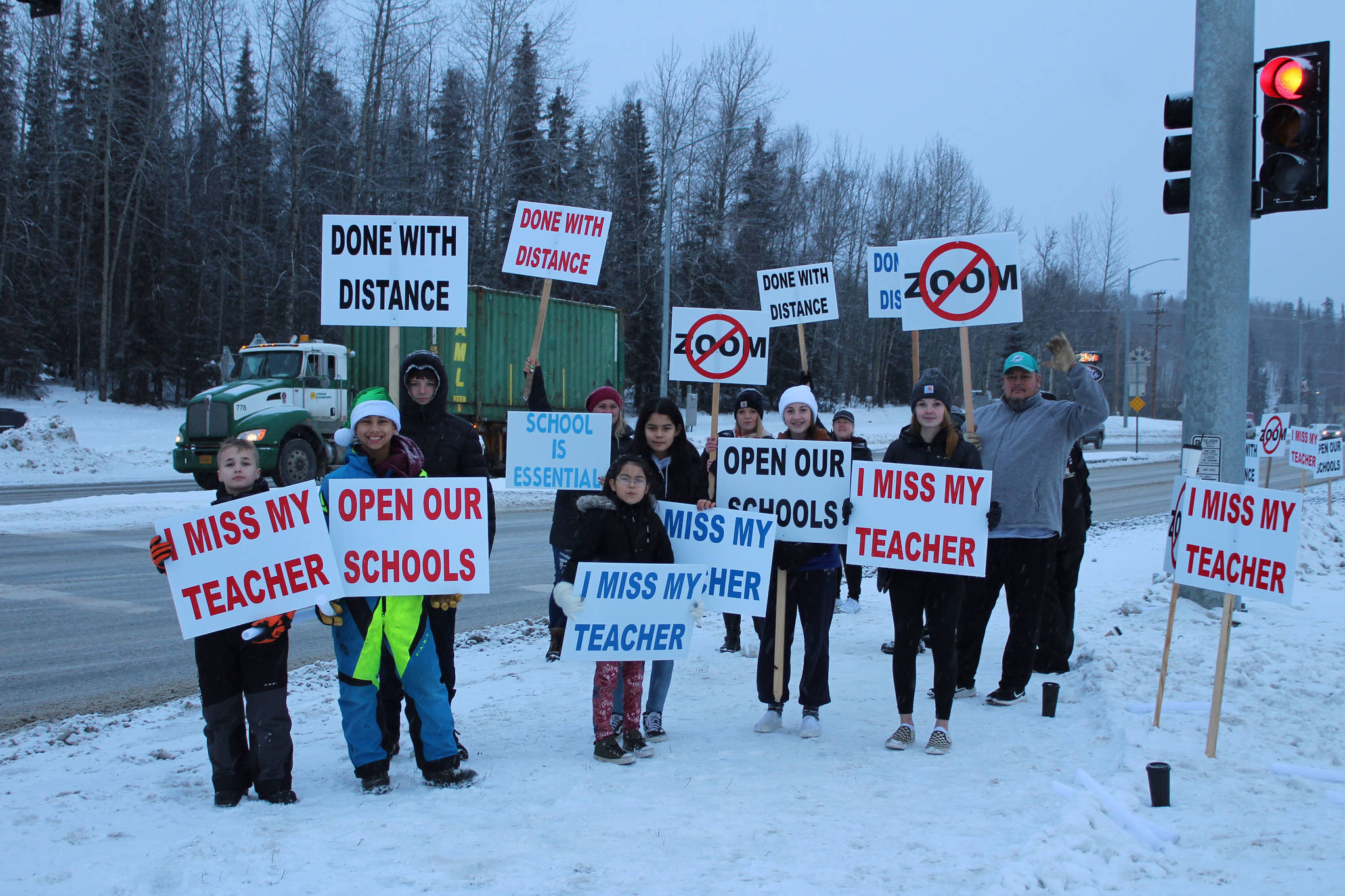 Protestors are seen at the intersection of Kenai Spur Hwy. and Sterling Hwy. on Tuesday, Dec. 15, 2020 in Soldotna, Alaska. (Photo by Ashlyn O’Hara/Peninsula Clarion)