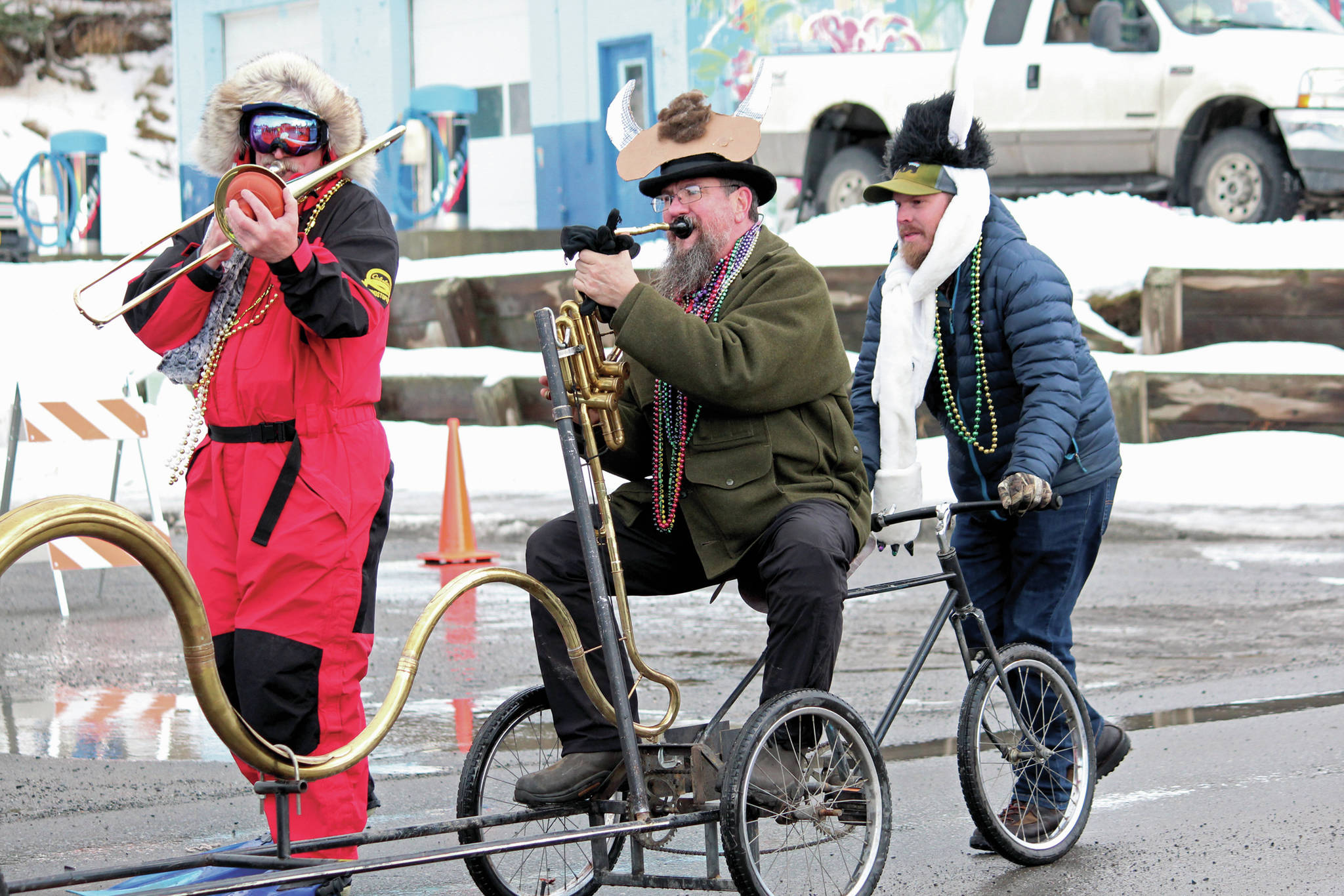 A parade participant plays a bike horn with the Krewe of Gambrinus float during this year’s Homer Winter Carnival Parade on Saturday, Feb. 8, 2020 in Homer, Alaska. (Photo by Megan Pacer/Homer News)