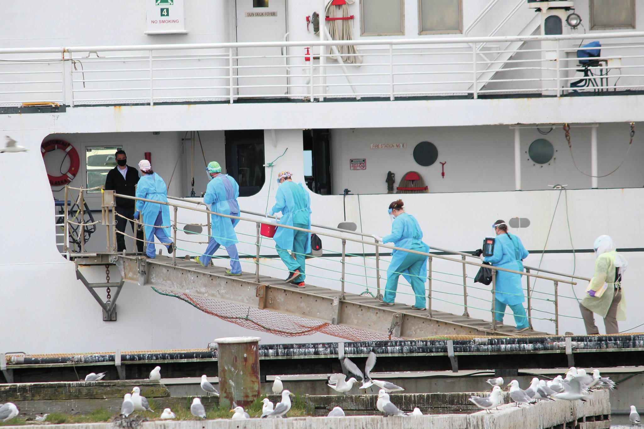 Staff from South Peninsula Hospital and Homer Public Health board the M/V Tustumena to test 35 crew members and six passengers Monday, June 8, 2020 at the Homer Ferry Terminal in Homer, Alaska. (Photo by Megan Pacer/Homer News)