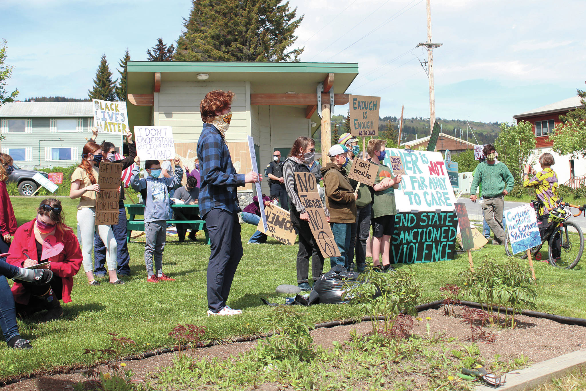 A group of locals protest at Wisdom, Knowledge, Faith and Love Park on Thursday, June 4, 2020 in Homer, Alaska. A local teacher organized a full week of daily protests supporting the Black Lives Matter movement at the park. (Photo by Megan Pacer/Homer News)