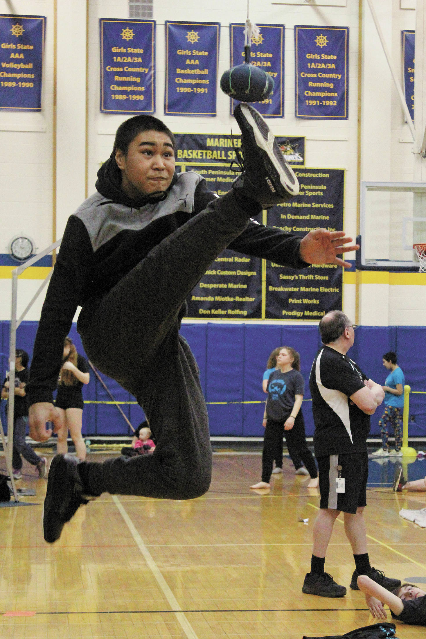 James Mishakoff of Tebughna School in Tyonek just misses connecting with the ball during the one-foot high kick event at the Kachemak Bay Traditional Games, a Native Youth Olymics invite, Saturday, March 7, 2020 at Homer High School in Homer, Alaska. (Photo by Megan Pacer/Homer News)