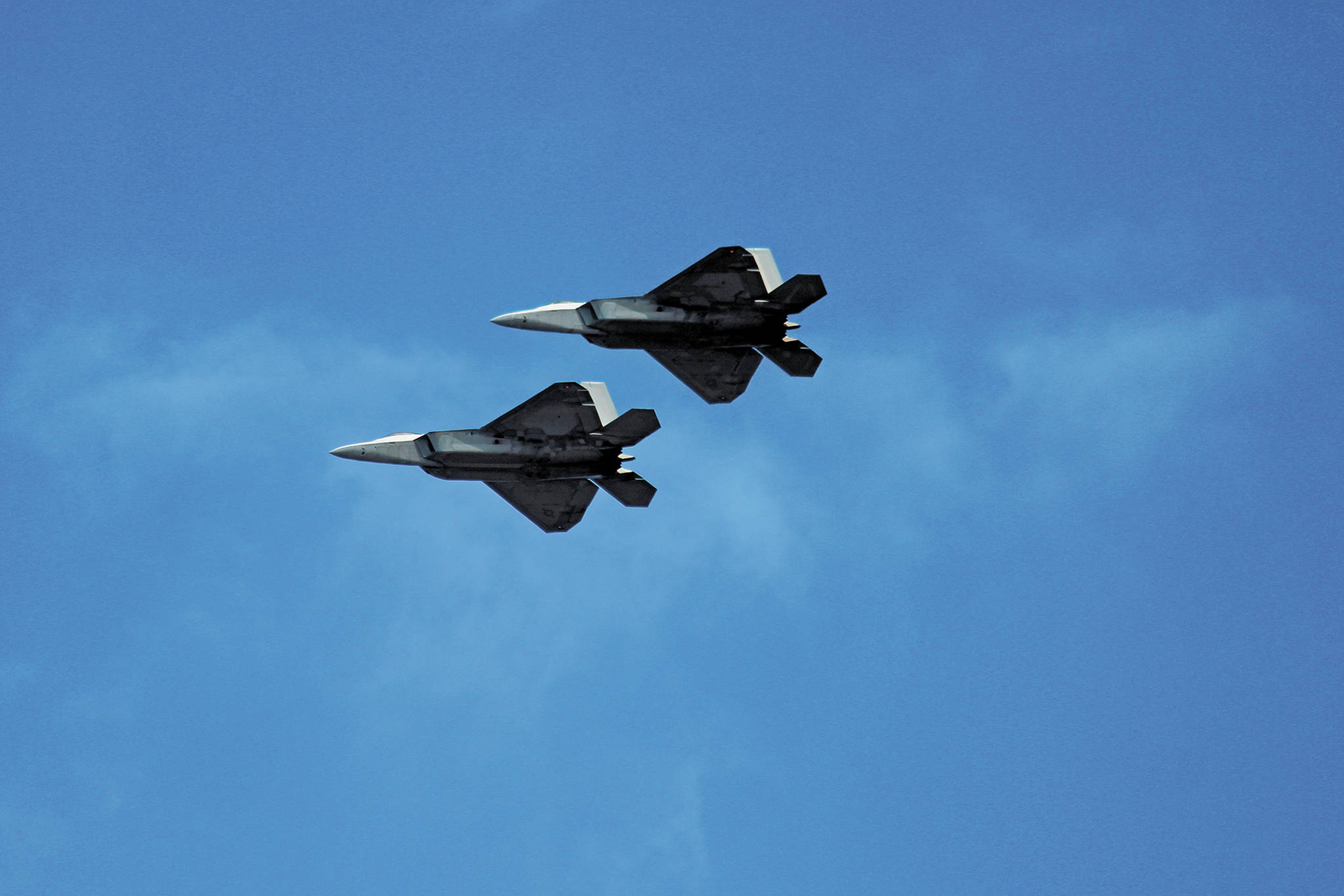 Two F-22s fly over Beluga Lake on Friday, May 15, 2020 as part of a statewide flyover event put on by the U.S. Air Force and Air National Guard. Four of the aircraft flew over Homer, Alaska and other parts of the state as a way to show support for health care workers and other COVID-19 front line workers. (Photo by Megan Pacer/Homer News)