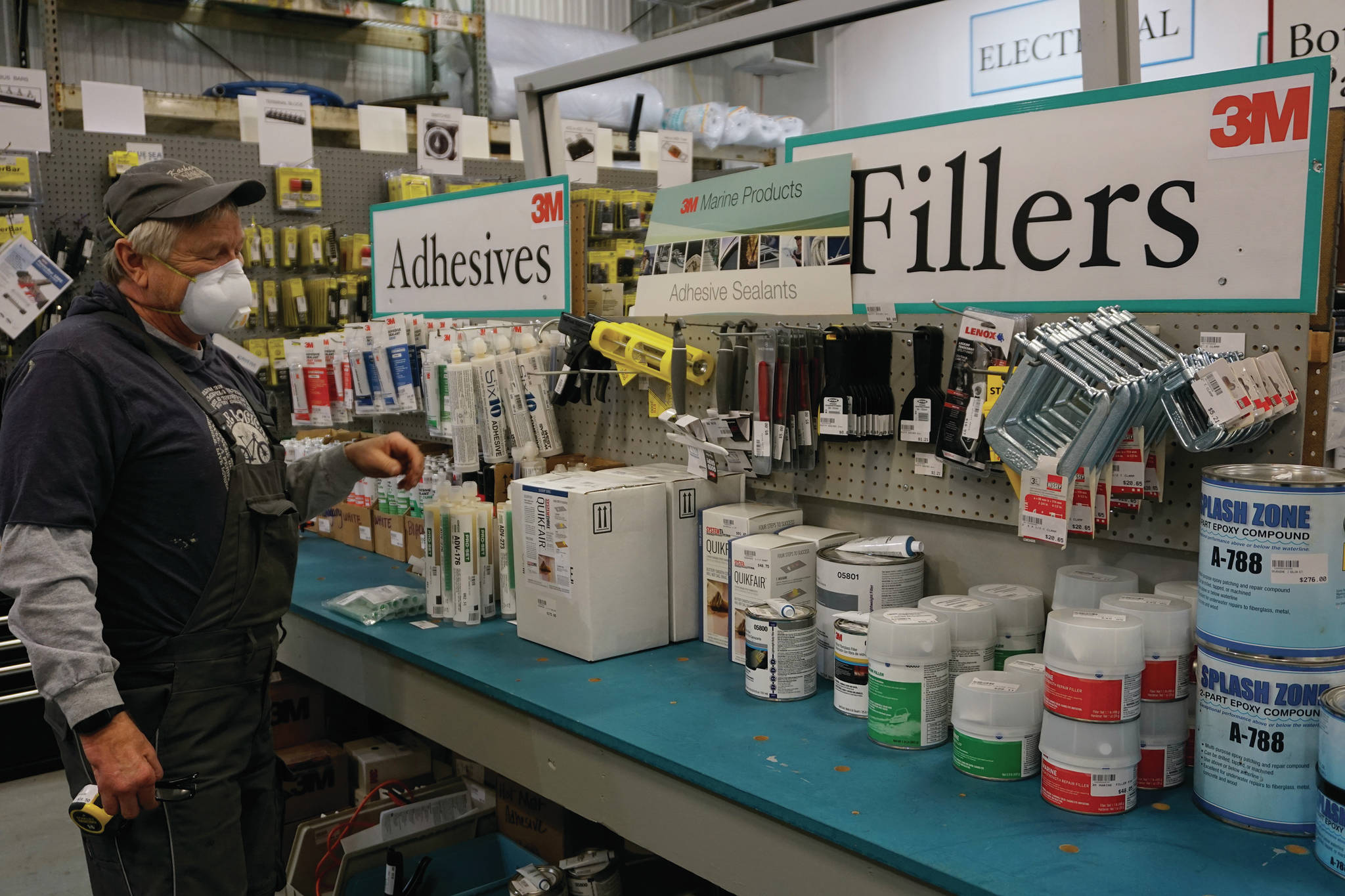 Eric Sloth, owner of Homer Marine, stands by a display of 3M products on Thursday, Dec. 17, 2020, at his store in the Northern Enterprise Boatyard in Homer, Alaska. (Photo by MIchael Armstrong/Homer News)