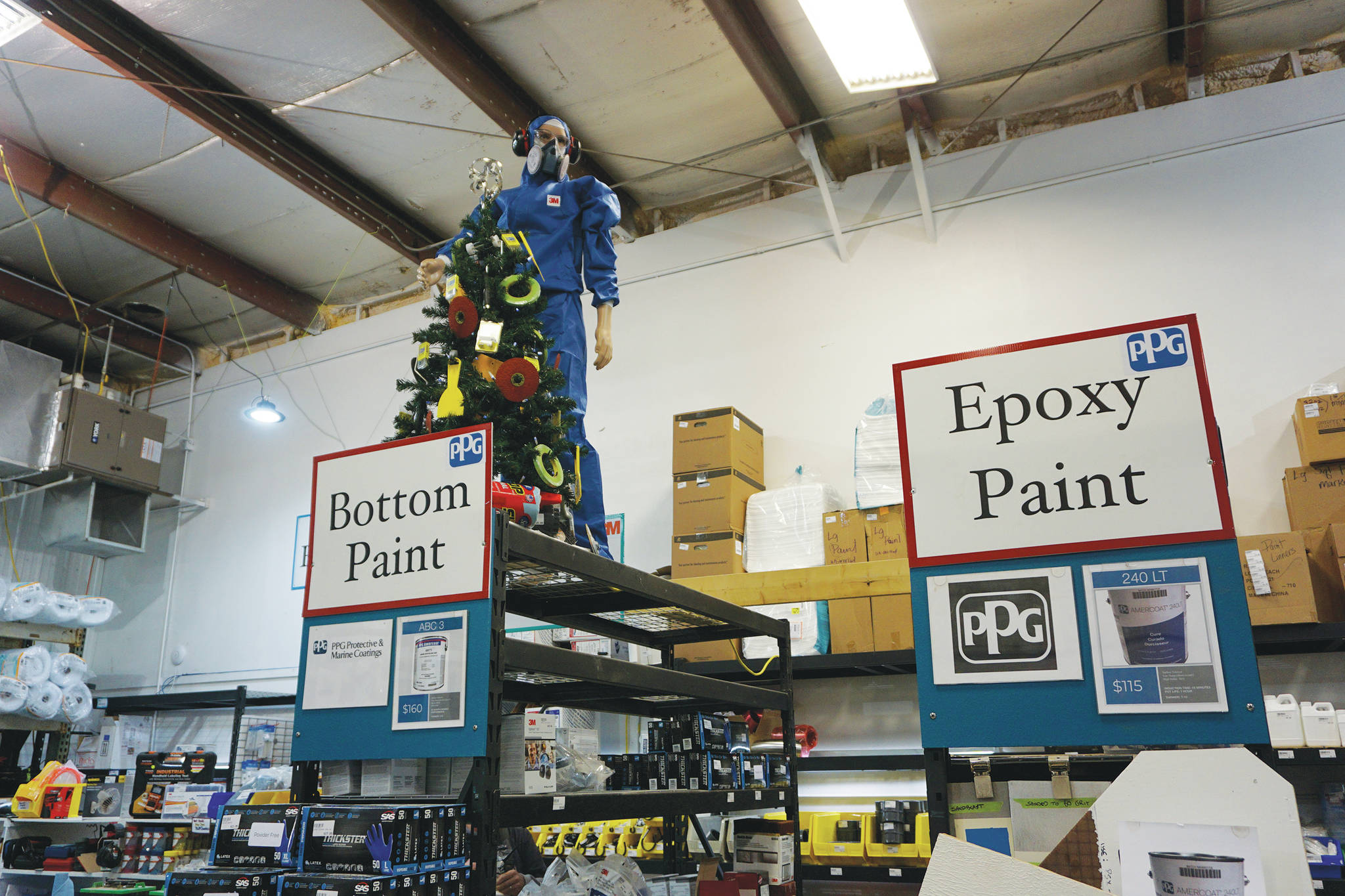 The display at Homer Marine includes Charlie, a mannequin wearing industrial safety gear like ear protectors and respirators, as seen here on Thursday, Dec. 17, 2020, at the store in the Northern Enterprises Boatyard in Homer, Alaska. (Photo by Michael Armstrong/Homer News)