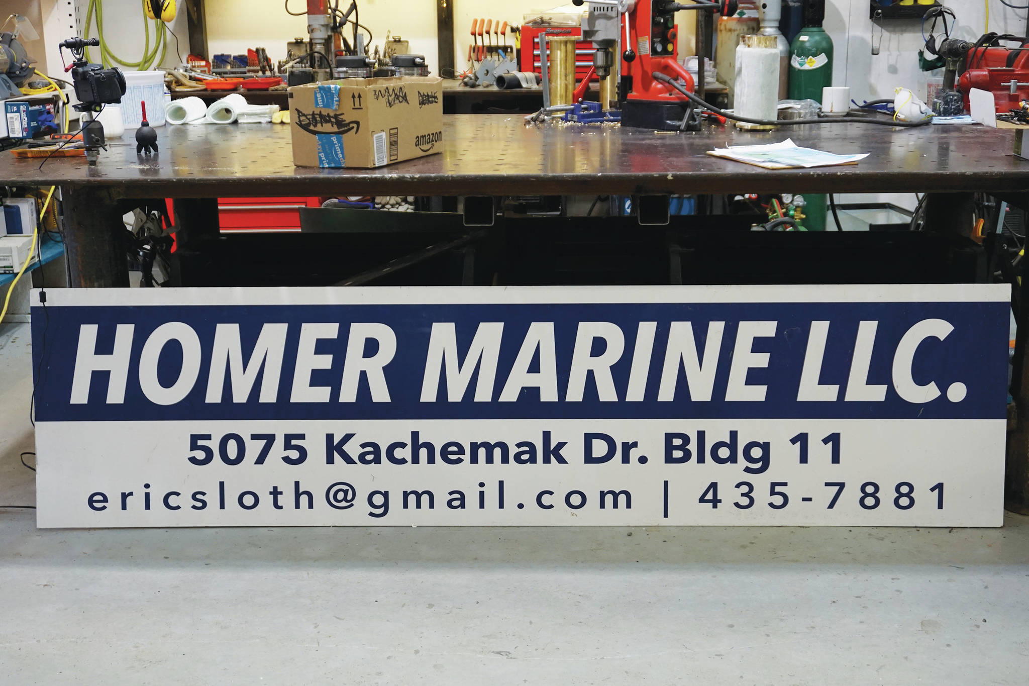The new sign for Homer Marine is waiting to be installed on Thursday, Dec. 17, 2020, at the store in the Northern Enterprises Boatyard in Homer, Alaska. (Photo by Michael Armstrong/Homer News)