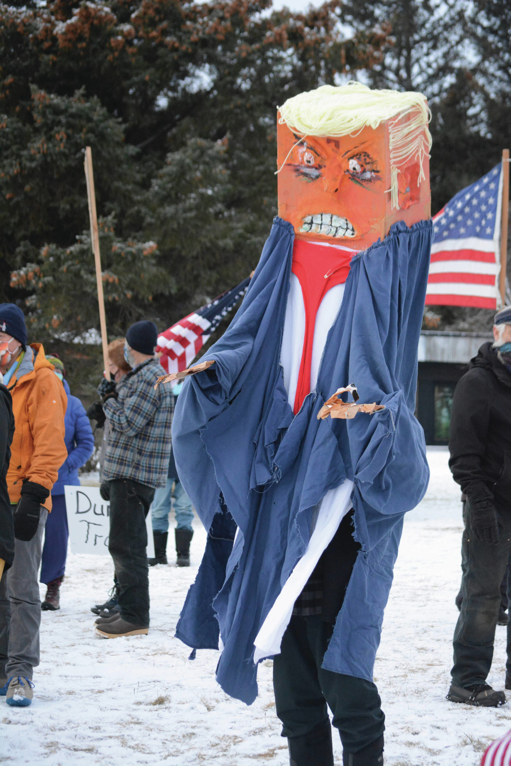 Charles Aguilar wears a President Donald Trump puppet at a protest against Trump on Saturday, Jan. 9, 2021, at WKFL Park in Homer, Alaska. He was part of about 50 people who reacted to the events of Jan. 6, 2021, in which rioters broke into the U.S. Capitol while Congress attempted to tally the Electoral College results in which former Vice President Joe Biden won the presidential election. (Photo by Michael Armstrong/Homer News)
