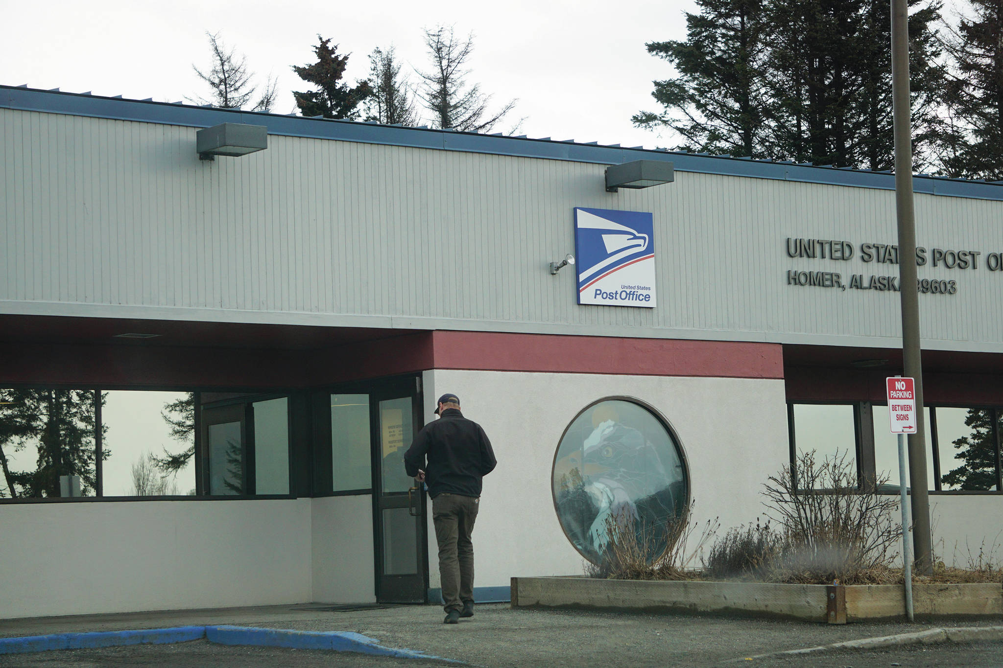 A man enters the Homer Post Office on Thursday, Jan. 21, 2021, in Homer, Alaska. On Jan. 20, 2021, President Joe Biden issued an executive order directing that federal employees and people in federal buildings should all wear masks. (Photo by Michael Armstrong/Homer News)