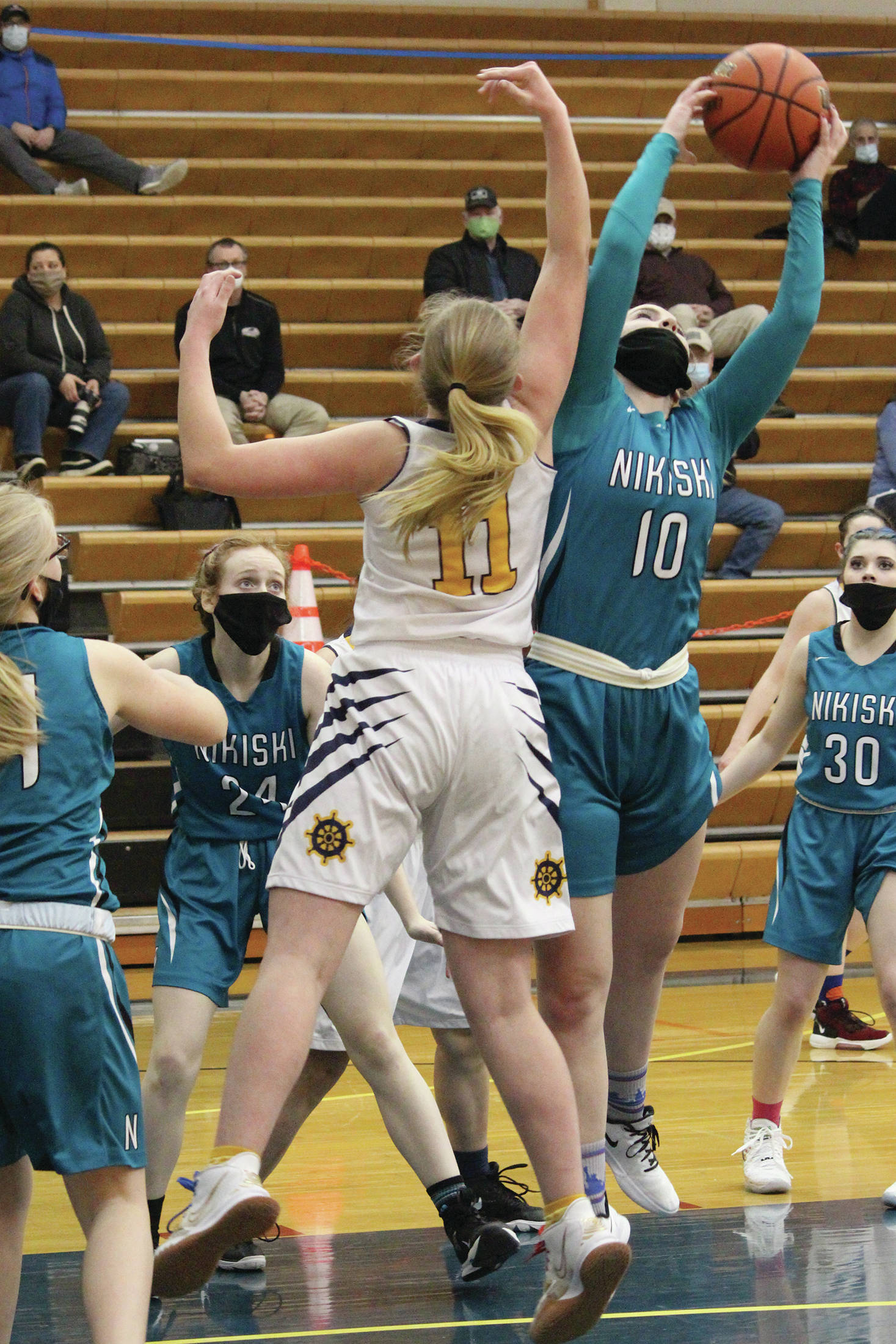 Lillian Carstens snags a rebound during a Tuesday, Feb. 2, 2021 basketball game between Nikiski and the Mariners at the Alice Witte Gymnasium in Homer, Alaska. (Photo by Megan Pacer/Homer News)