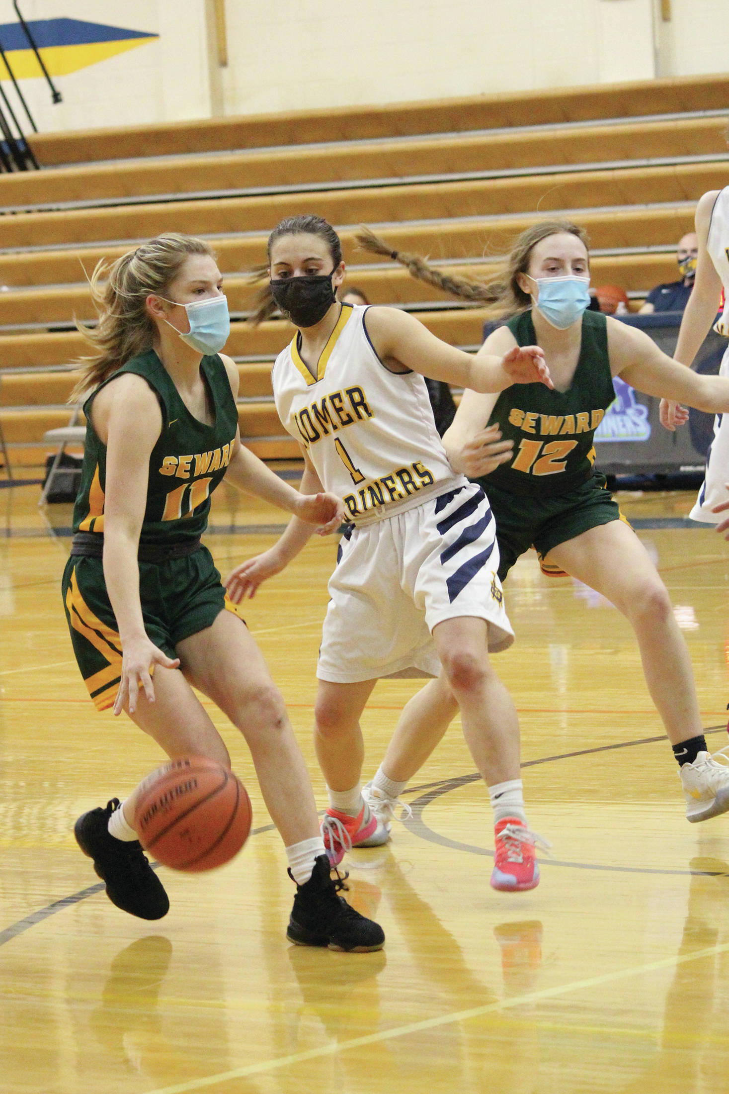Seward’s Lena Jagielski brings the ball down the court under pressure from Homer’s Sailey Rhodes during a Saturday, Jan. 30, 2021 basketball game at the Alice Witte Gymnasium in Homer, Alaska. (Photo by Megan Pacer/Homer News)