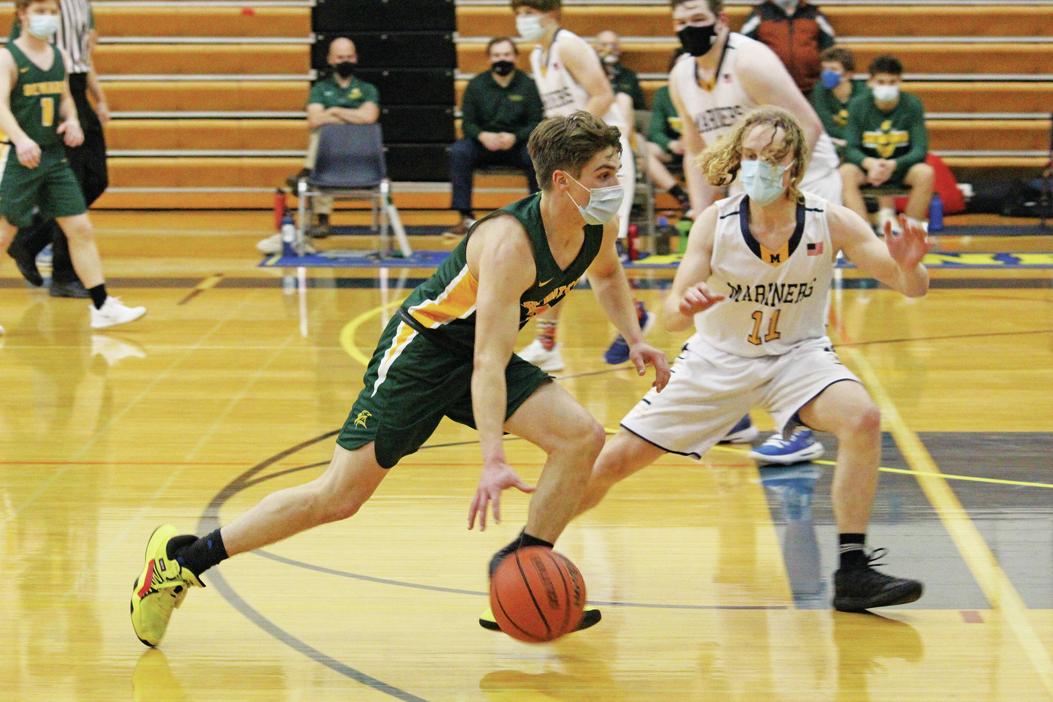 Seward’s Max Pfeiffenberger makes a move past Homer’s Parker Lowney during a Saturday, Jan. 30, 2021 basketball game at the Alice Witte Gymnasium in Homer, Alaska. (Photo by Megan Pacer/Homer News)