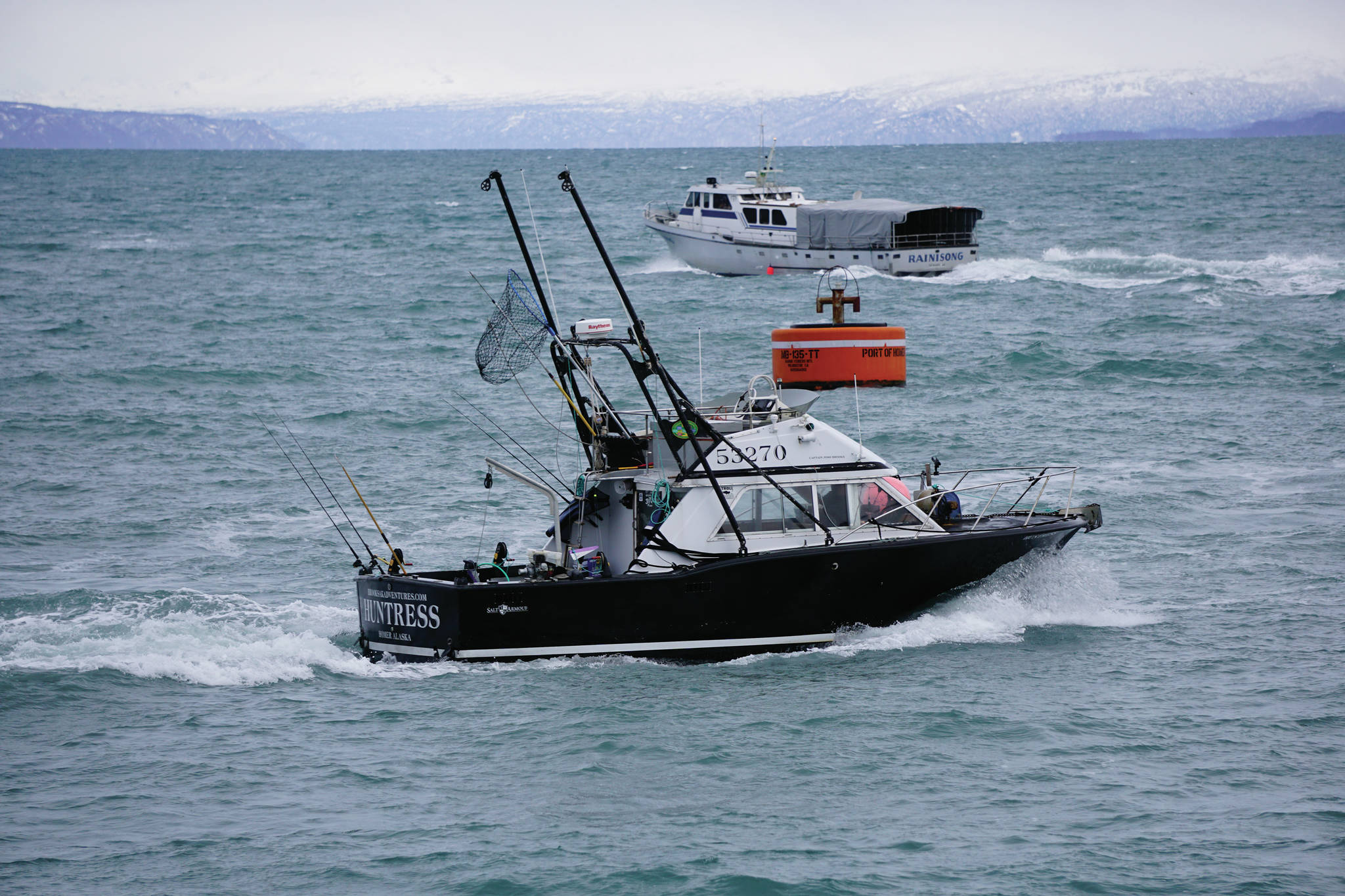 The Huntress, bottom, and the Rainisong, top, leave the Homer Harbor on Thursday, Jan. 28, 2021, in Homer, Alaska. (Photo by Michael Armstrong/Homer News)
