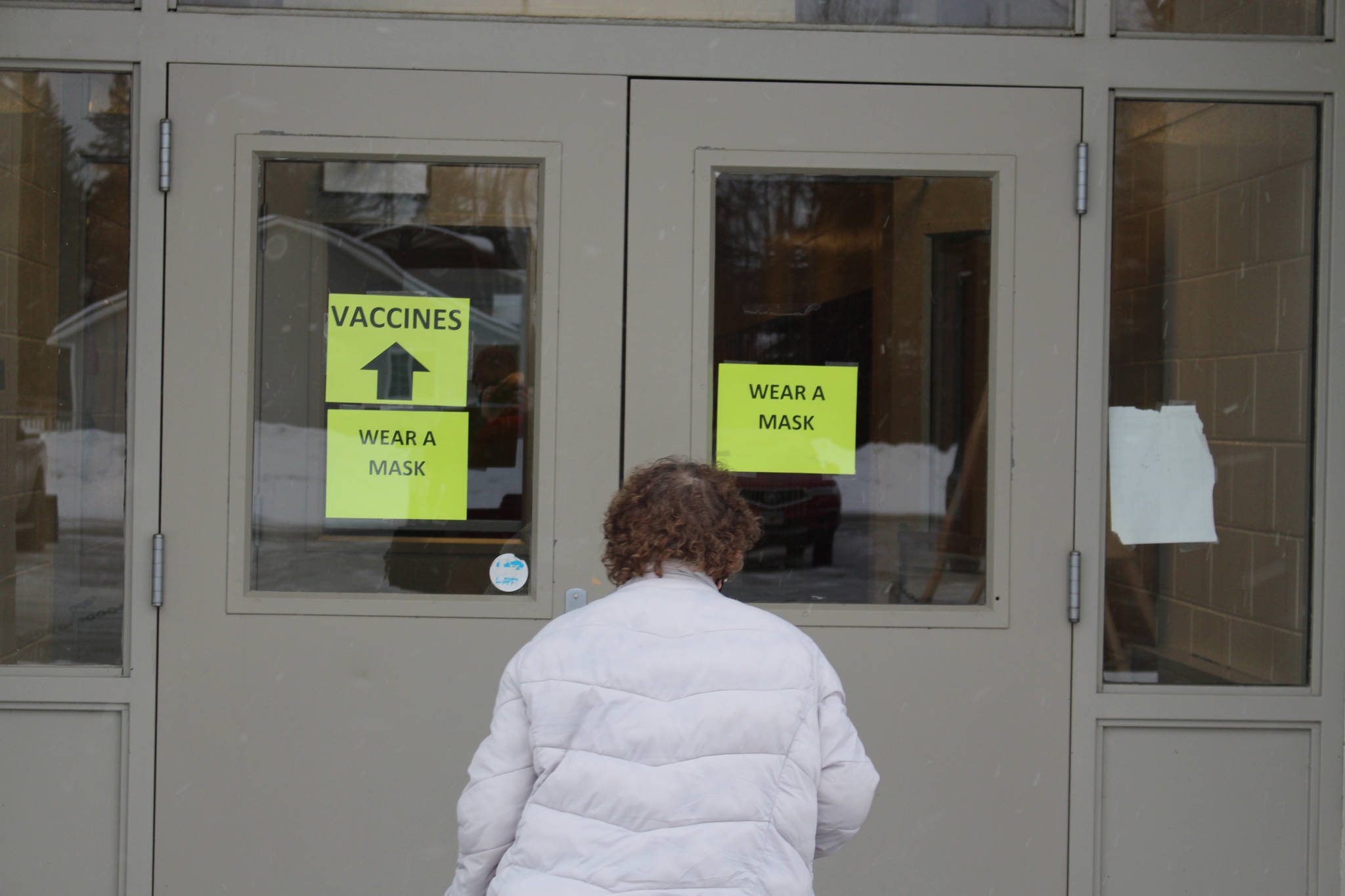 A Kenai Peninsula Resident walks in to the Soldotna Prep School for her vaccine appointment during a clinic hosted by the Kenai Peninsula Borough and Soldotna Professional Pharmacy in Soldotna, Alaska on Jan. 23, 2021. (Photo by Brian Mazurek/Peninsula Clarion)