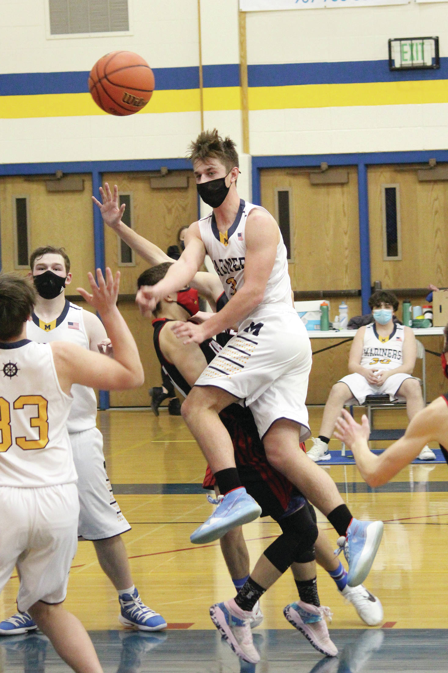 Homer’s Clayton Beachy passes the ball to a teammate during a Tuesday, Feb. 9, 2021 basketball game against Kenai Central at the Alice Witte Gymnasium in Homer, Alaska. (Photo by Megan Pacer/Homer News)